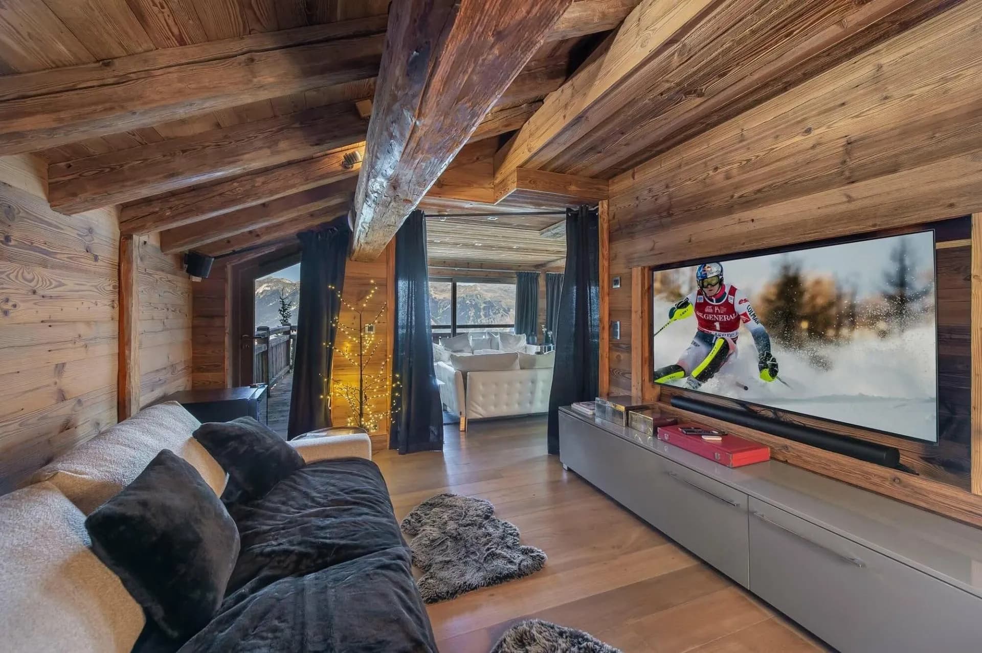 TV lounge with sofa and stone-and-timber walls