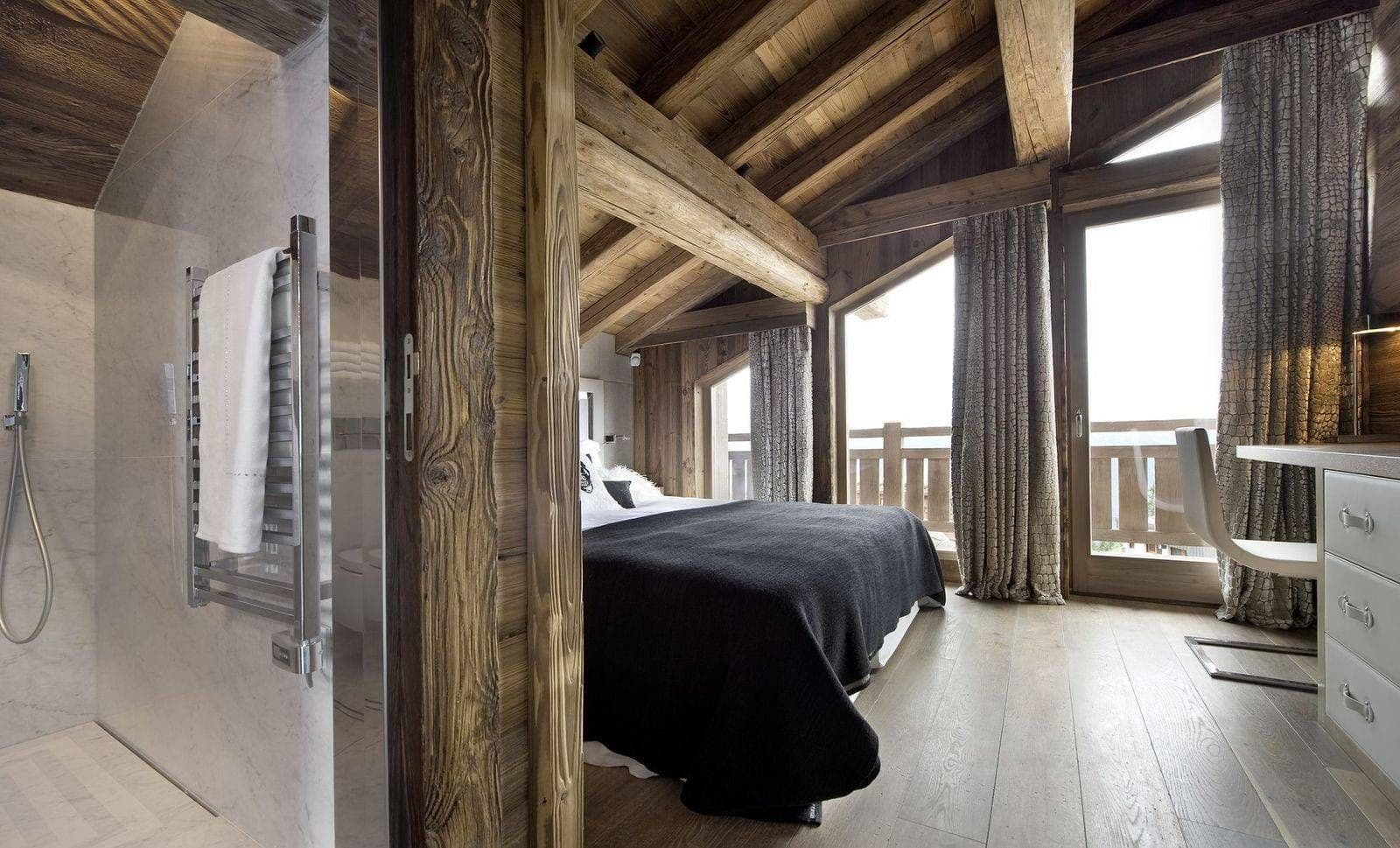 Double bedroom with floor-to-ceiling curtains and timber beams