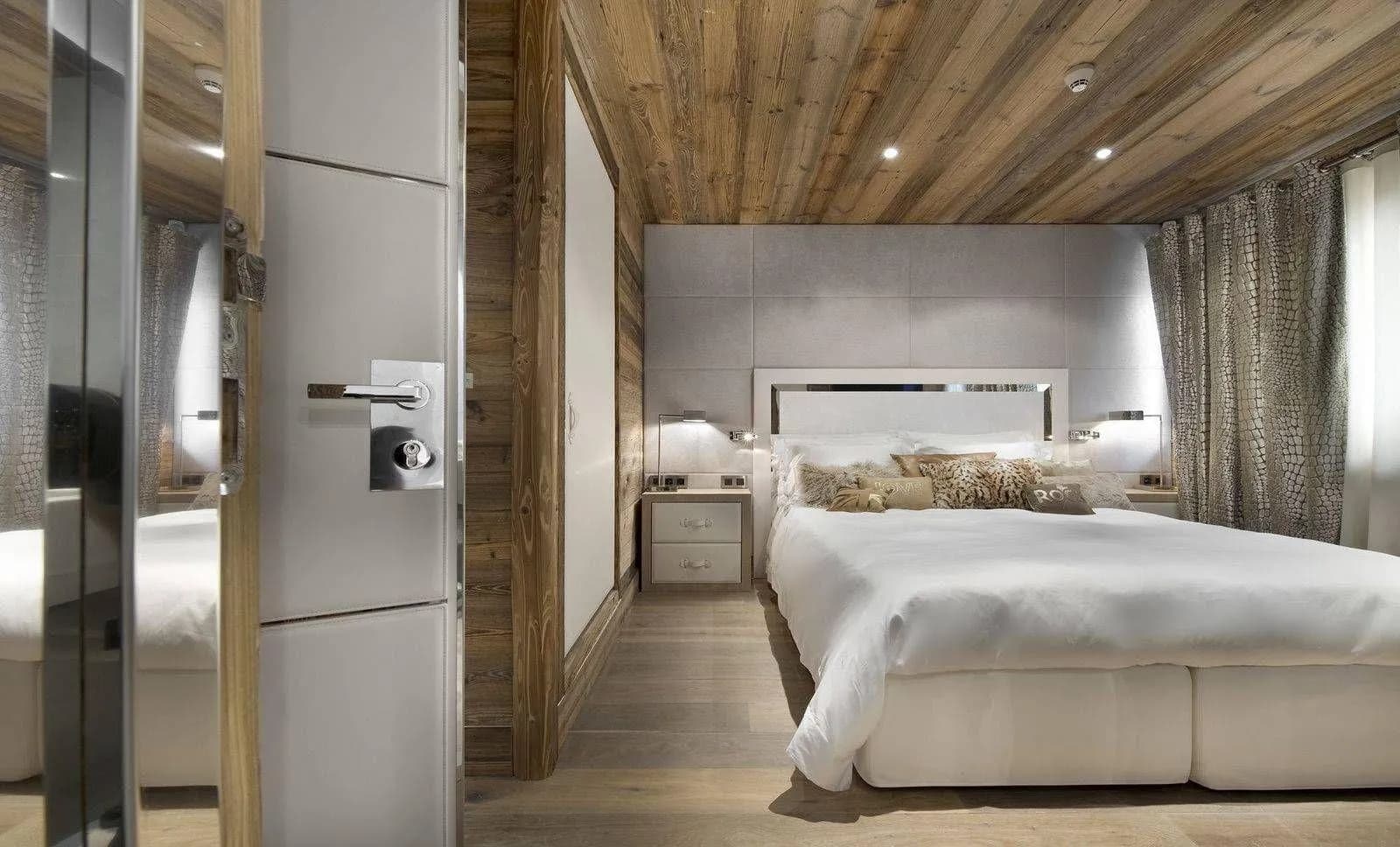 Double bedroom with timber ceiling and adjoining bathroom