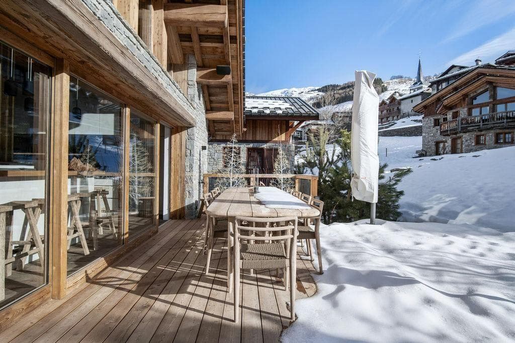 Wooden deck with dining table for 8 and alpine village views