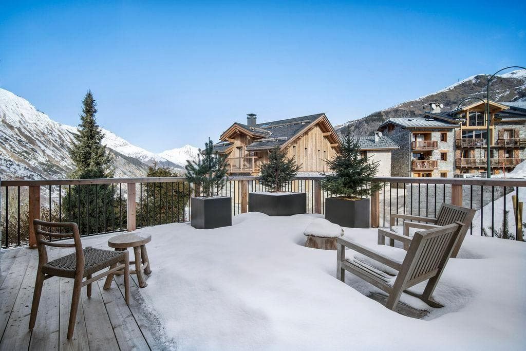 Private snow-covered deck with valley views and lounge seating