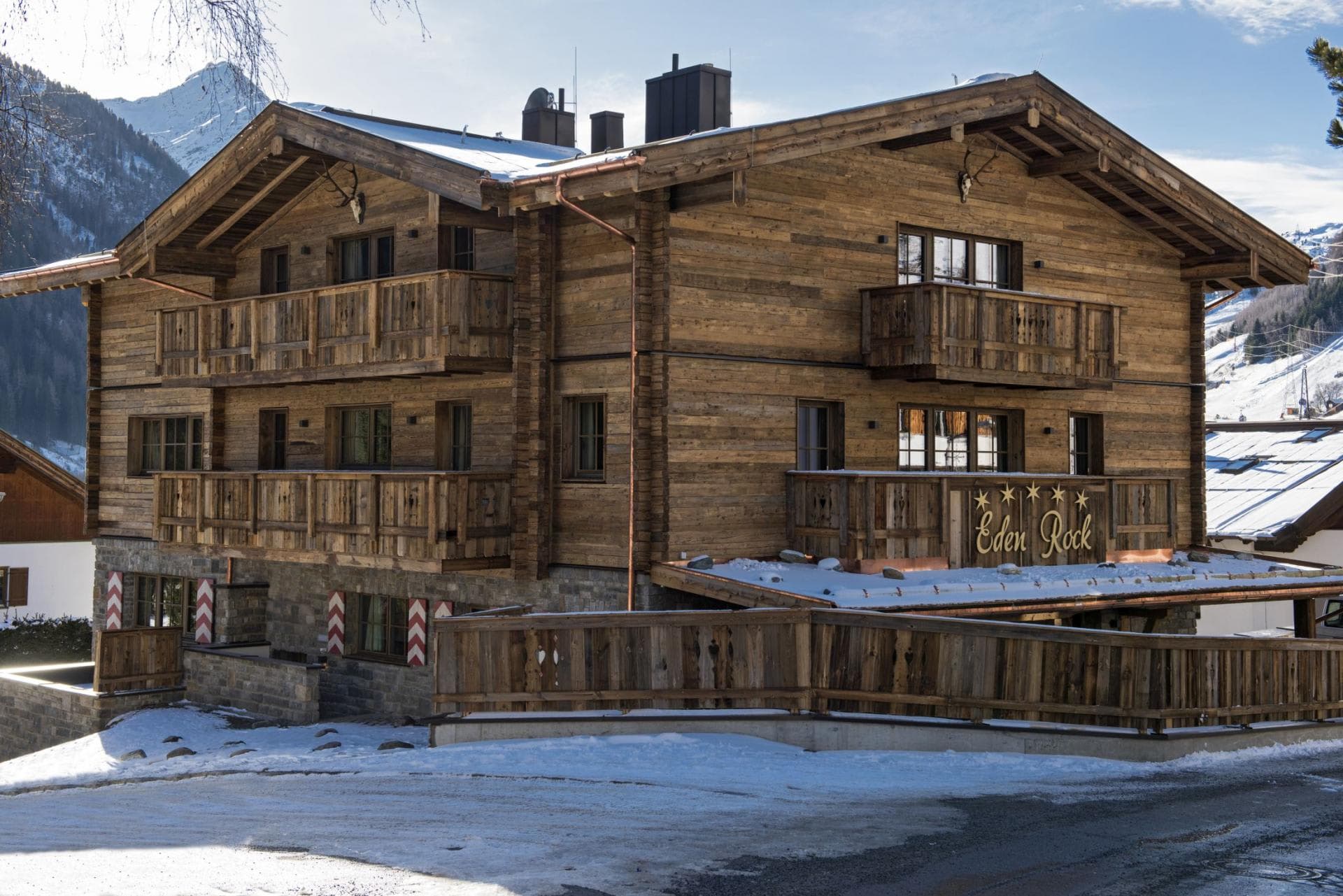 Chalet exterior with multiple private balconies and mountain views