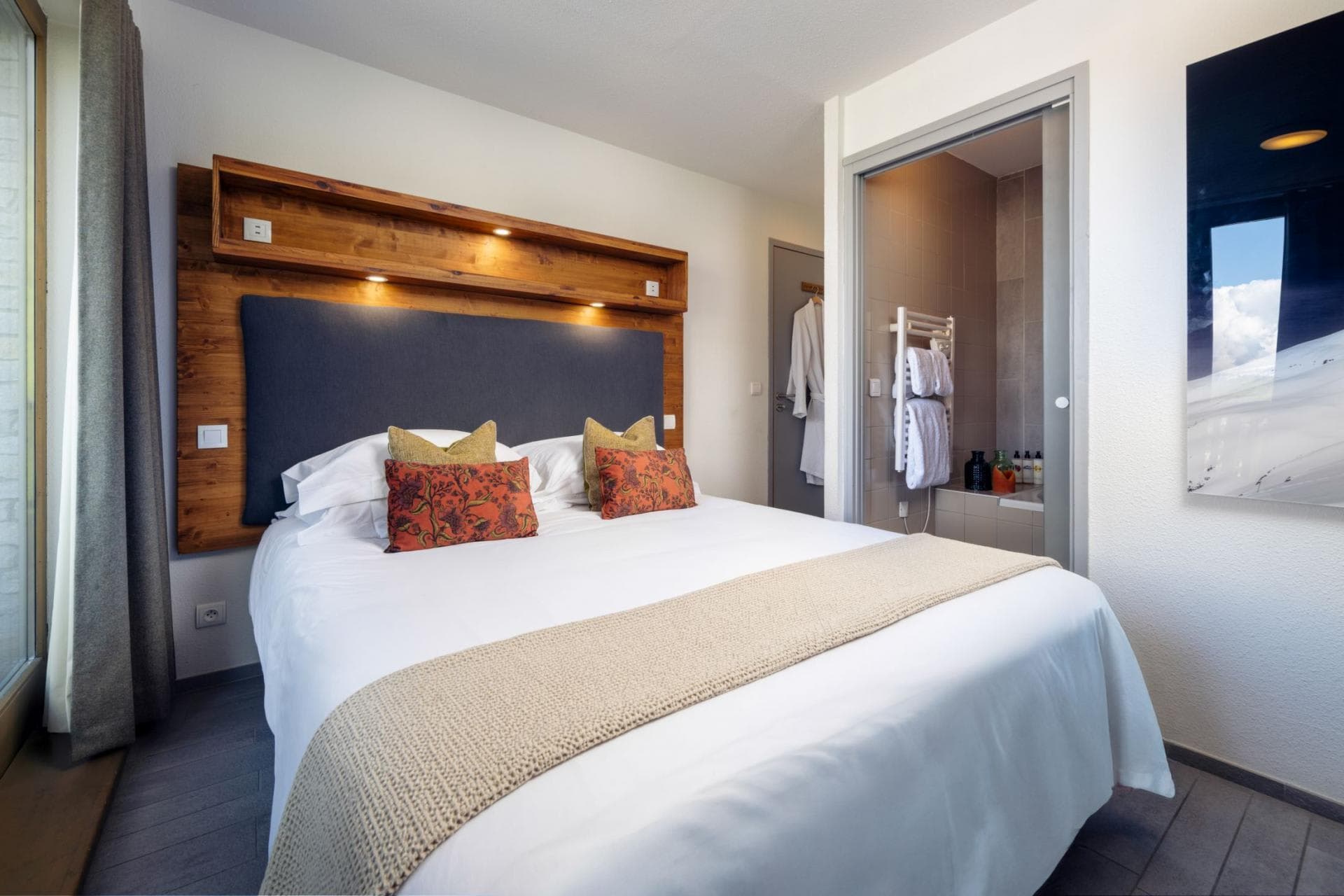 Bedroom with king bed and ensuite bathroom featuring soaking tub