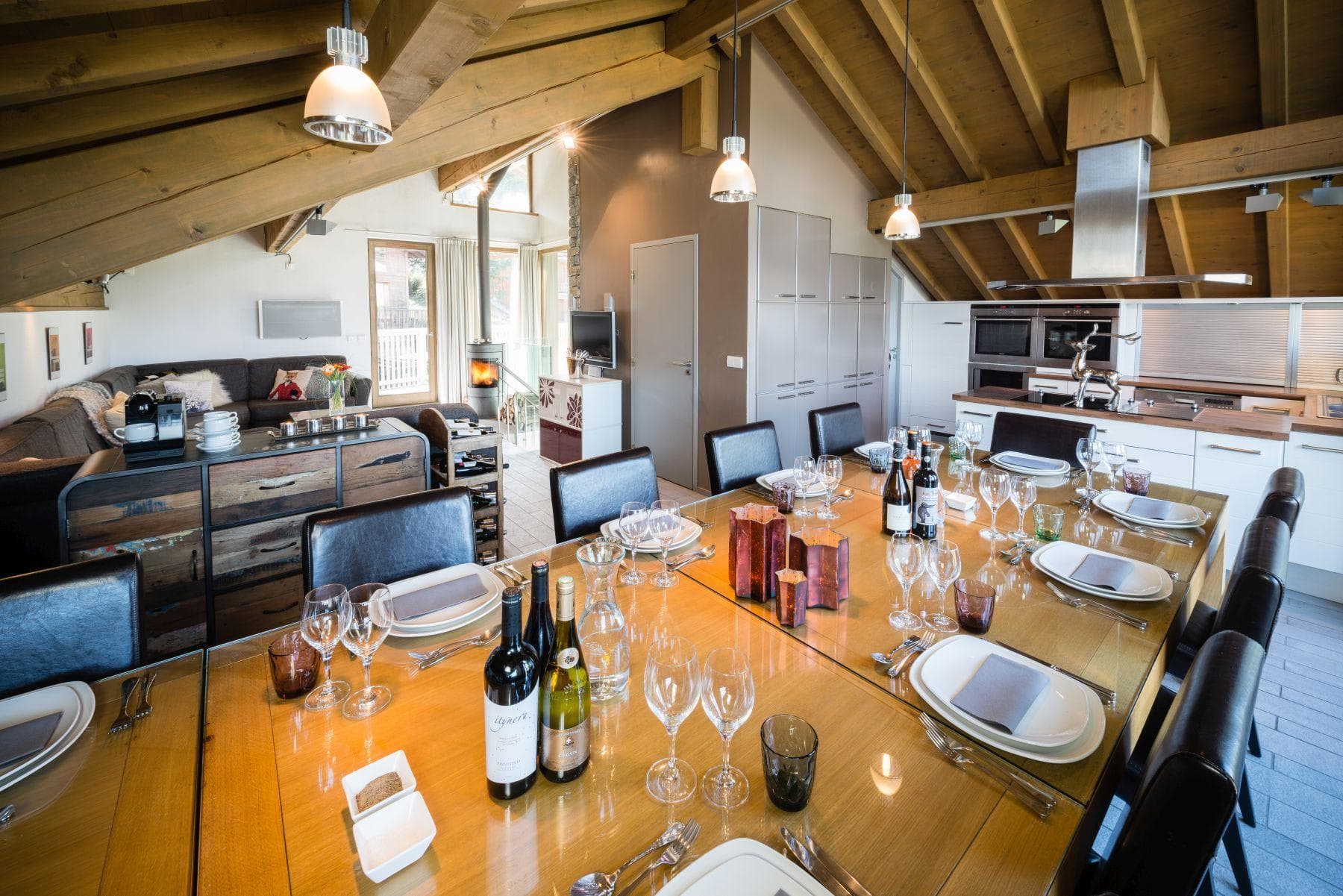 Dining table seats 10; open layout with vaulted beam ceilings