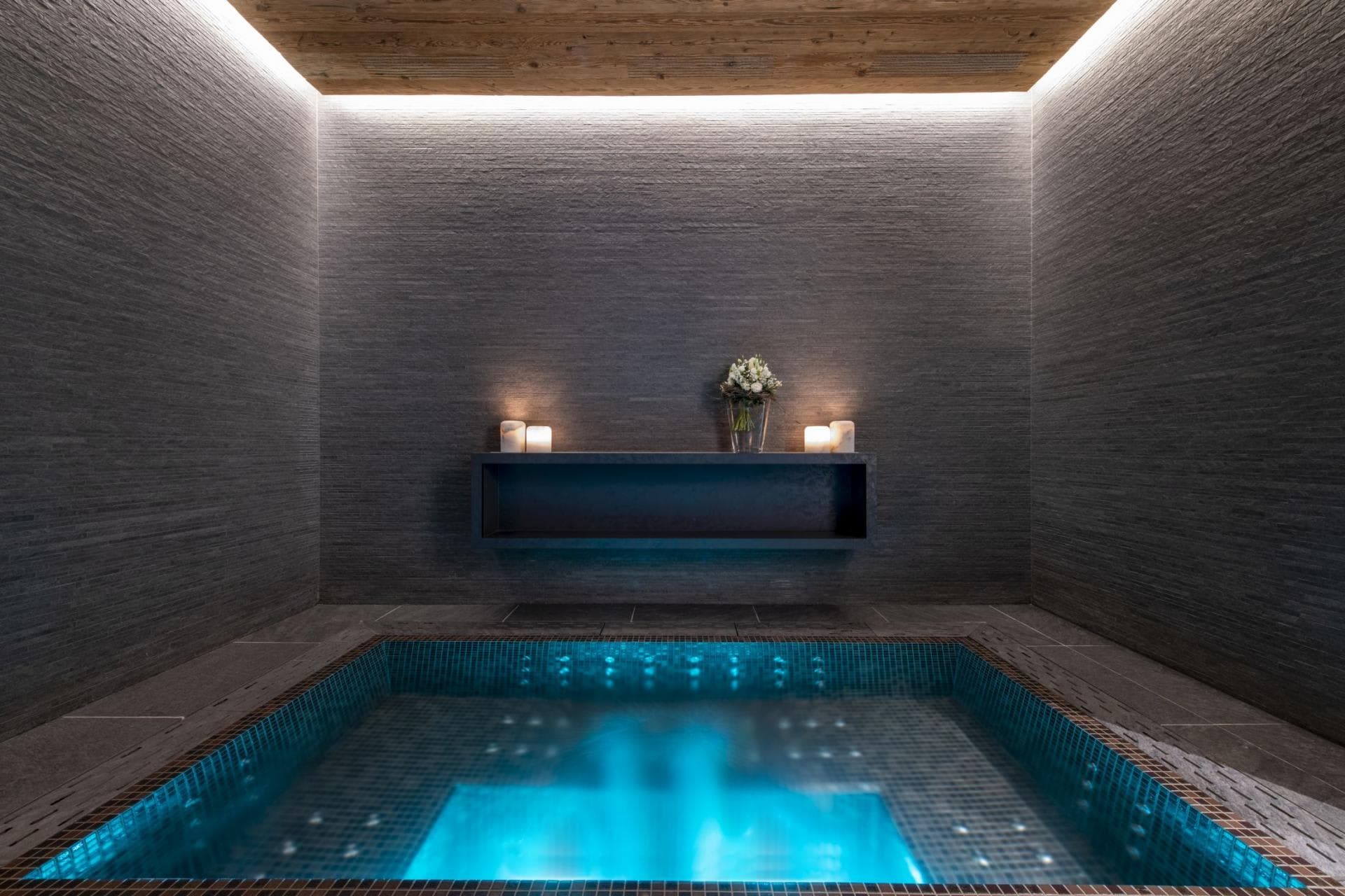 Indoor hot tub with mosaic tiling and integrated mood lighting