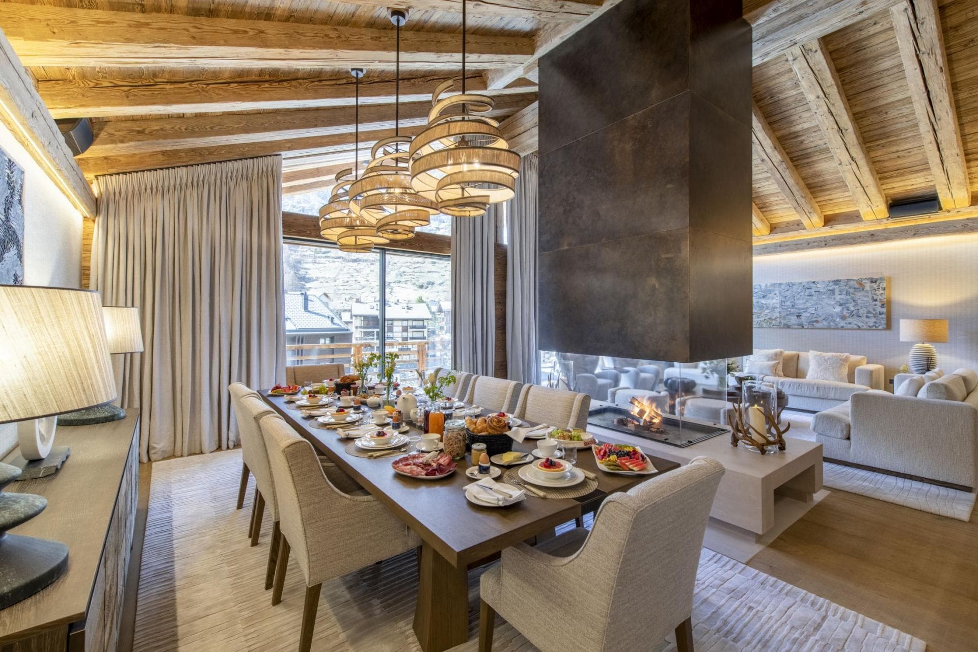 Dining area for 10 with double-sided fireplace and village views