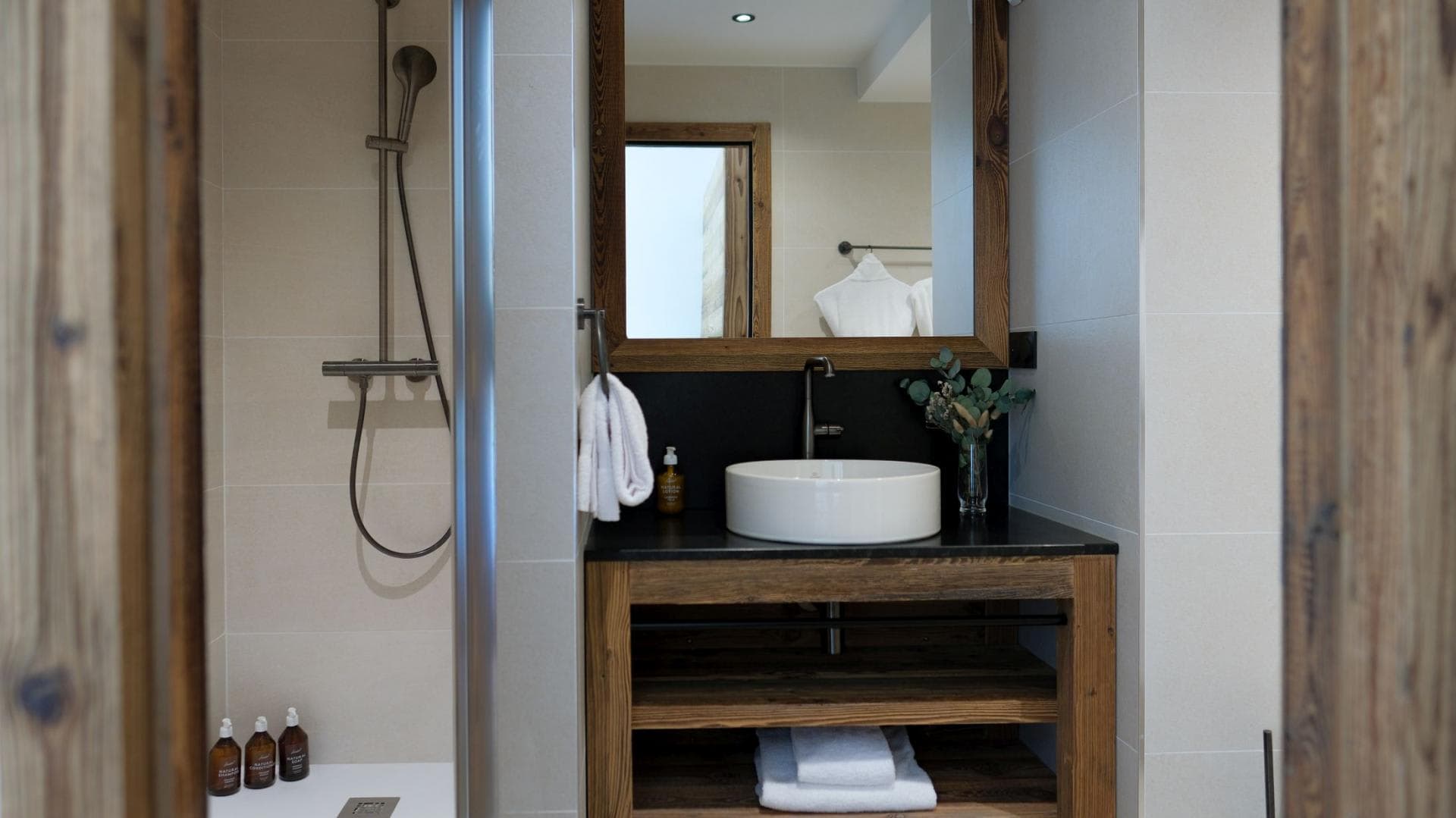 Bathroom with vessel sink and walk-in shower