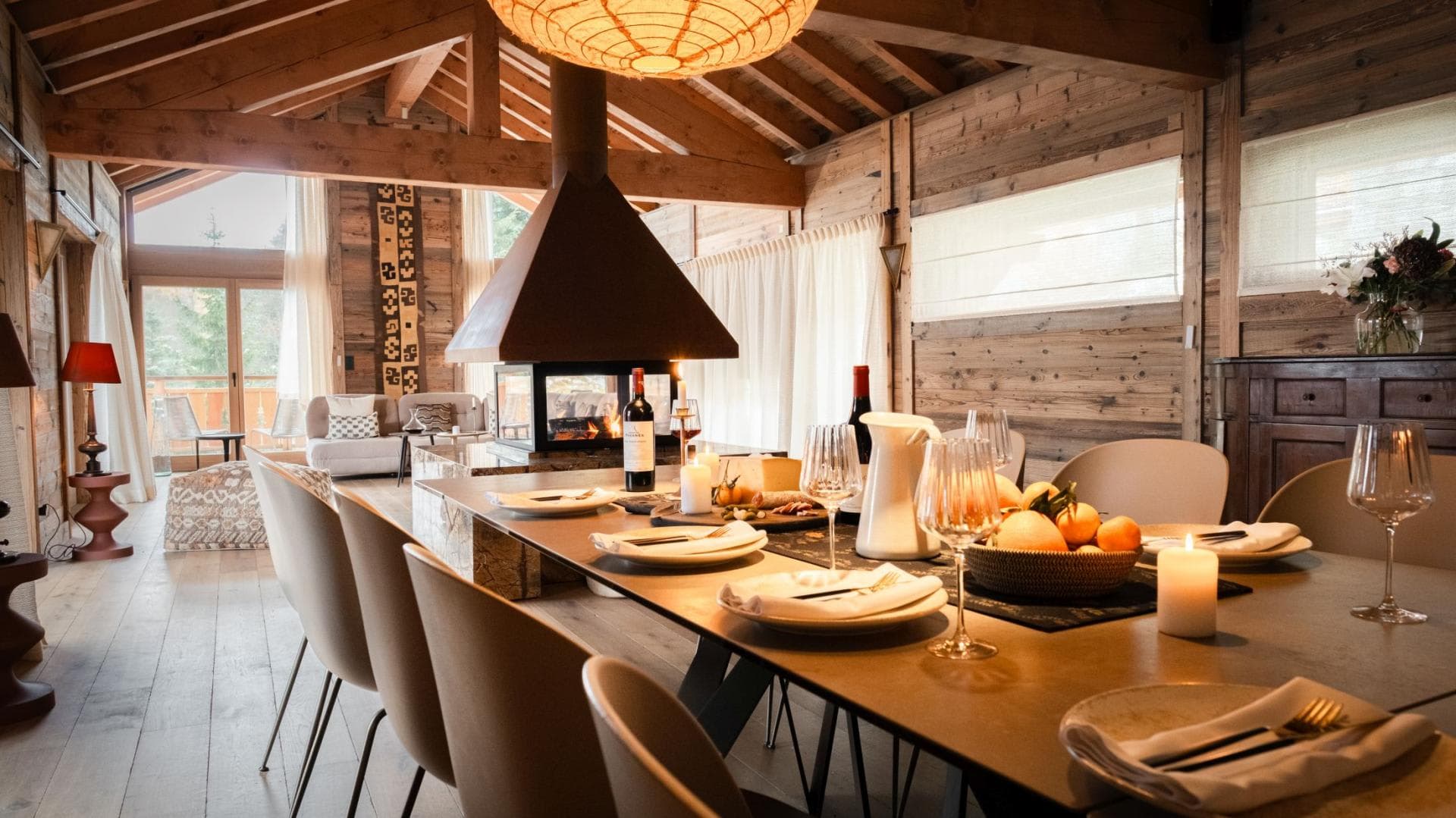 Dining area with seating for 8 and central glass-enclosed fireplace