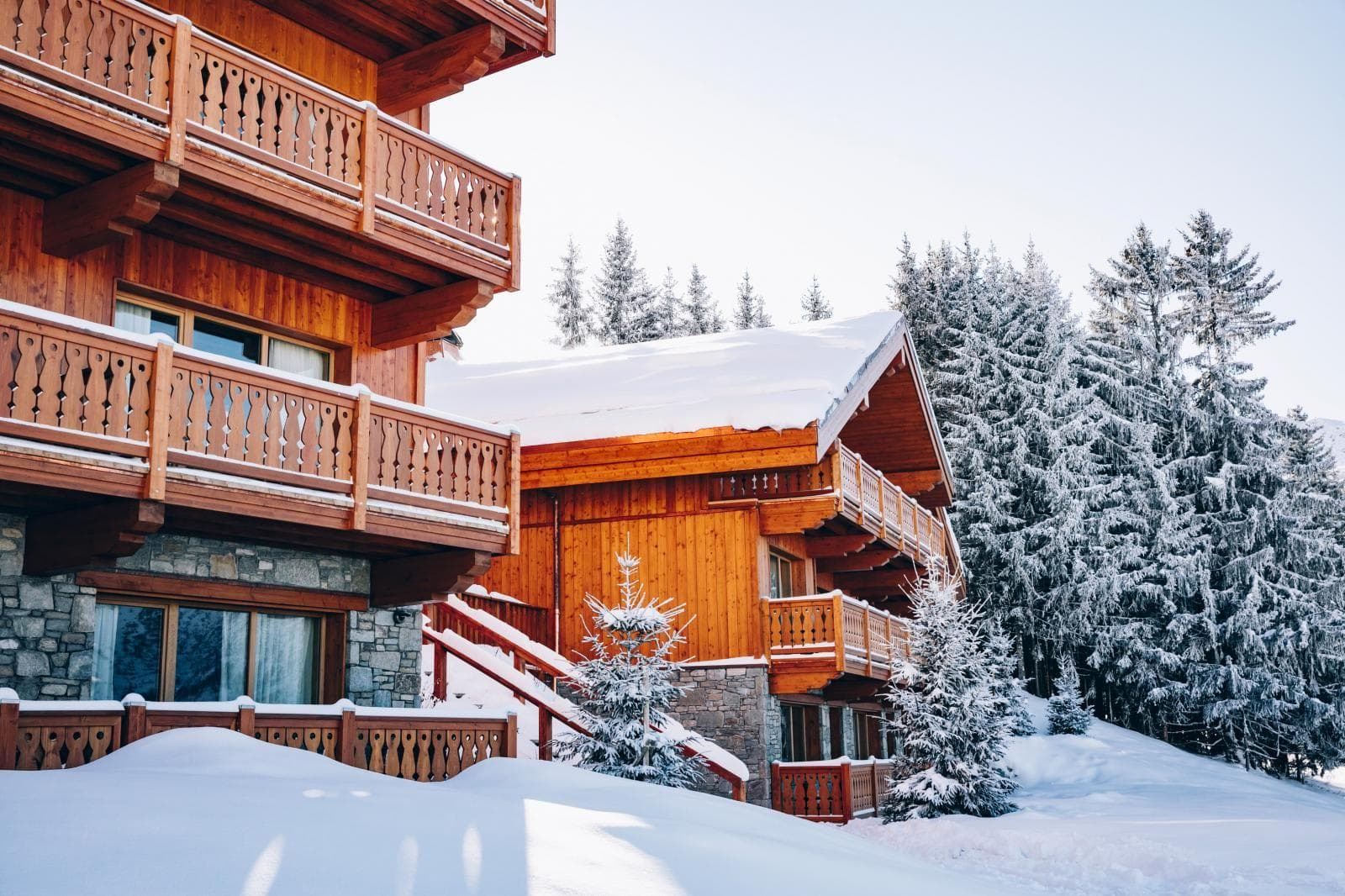 Ski-in/ski-out chalet with multi-level timber balconies and stone foundation
