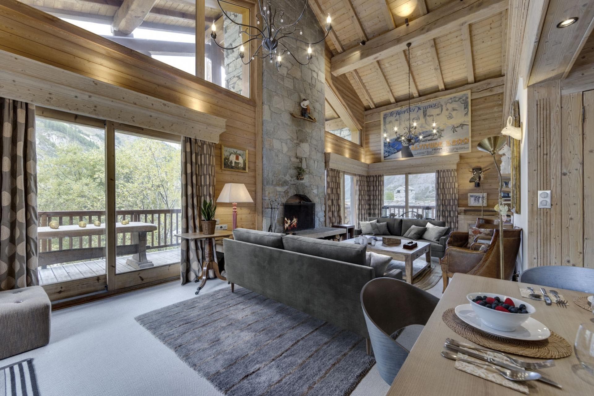 Living room with floor-to-ceiling stone fireplace and vaulted wood ceilings