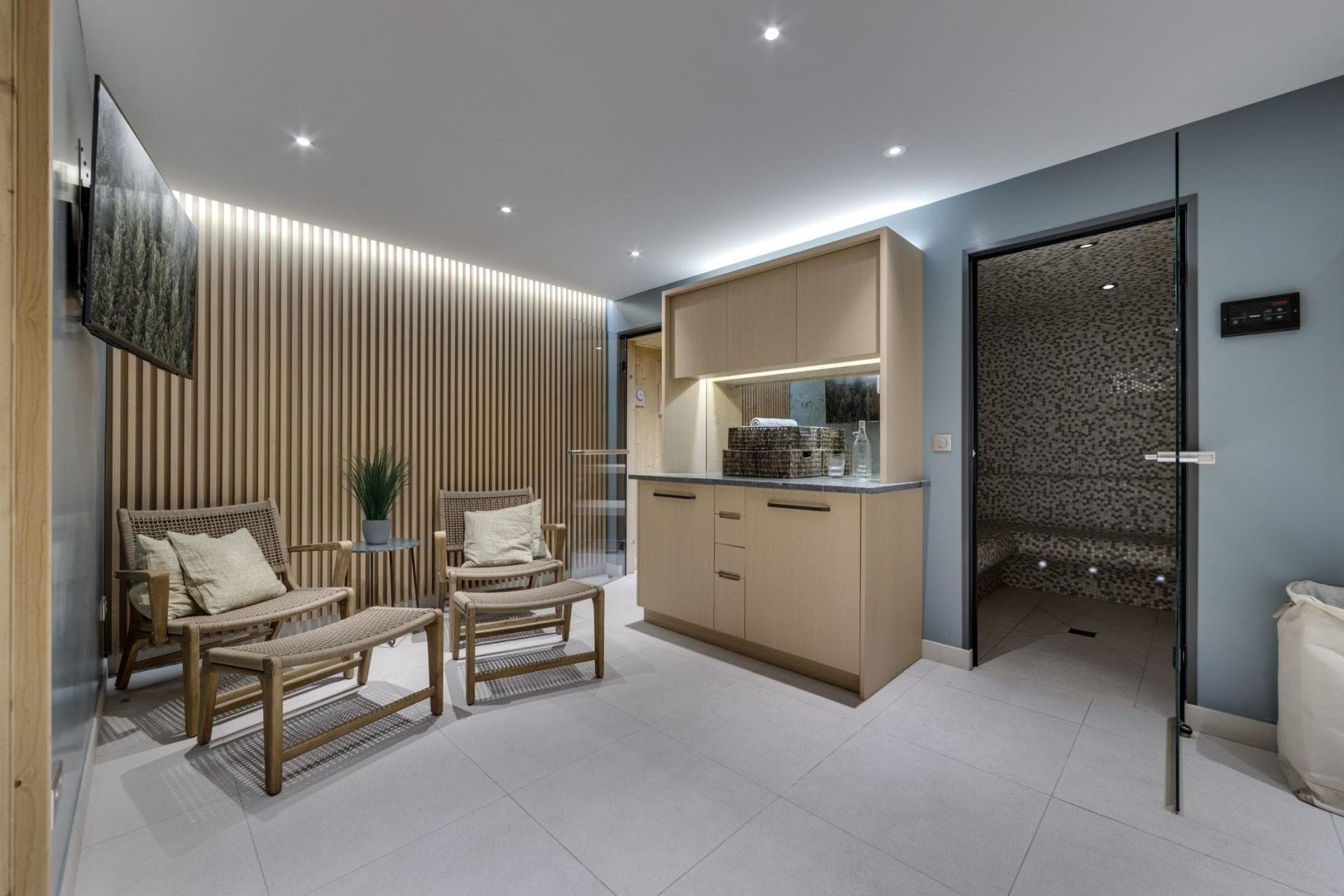 Wellness area with lounge seating and mosaic-tiled steam room