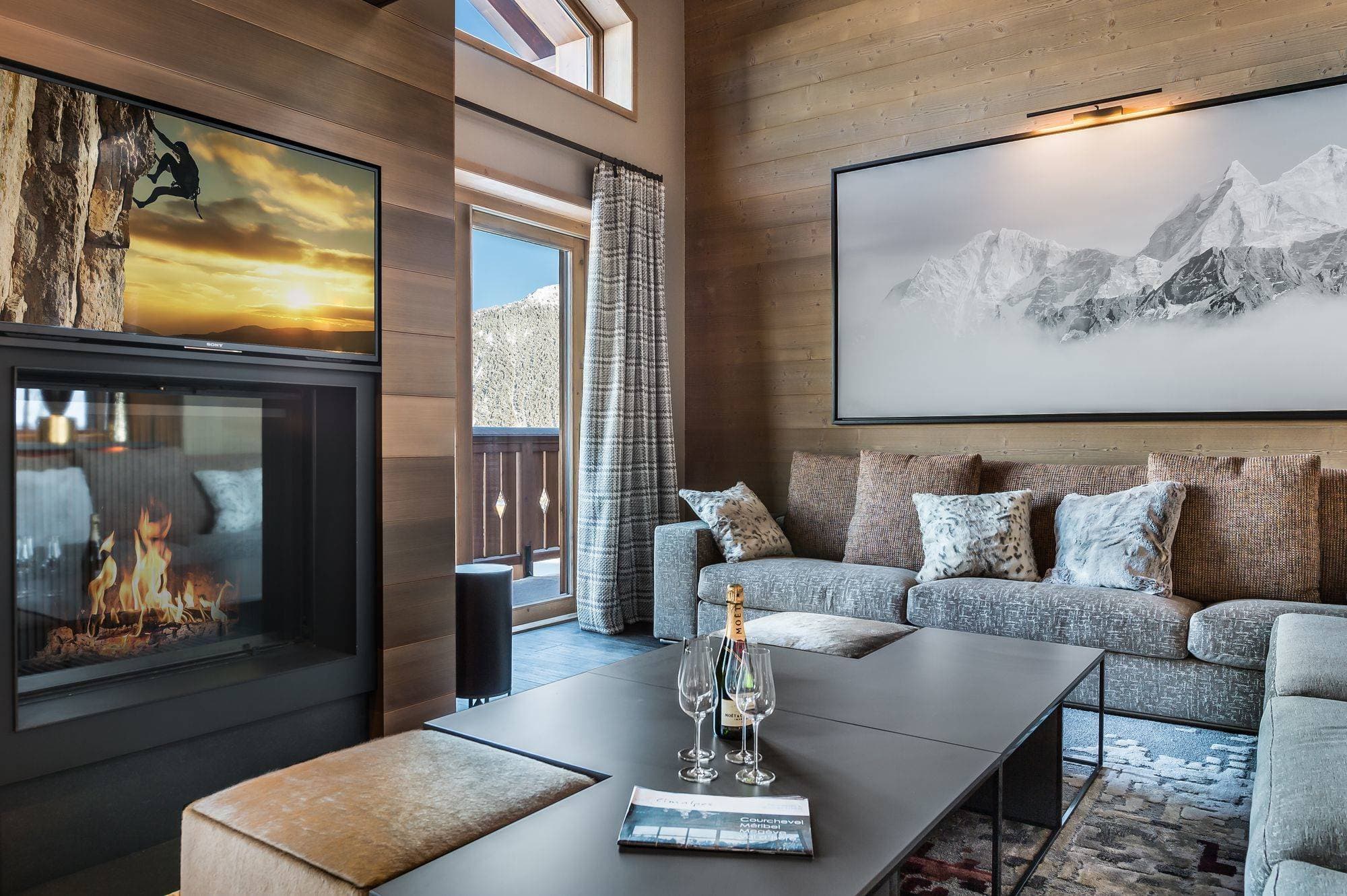 Living area with gas fireplace and private mountain-view balcony