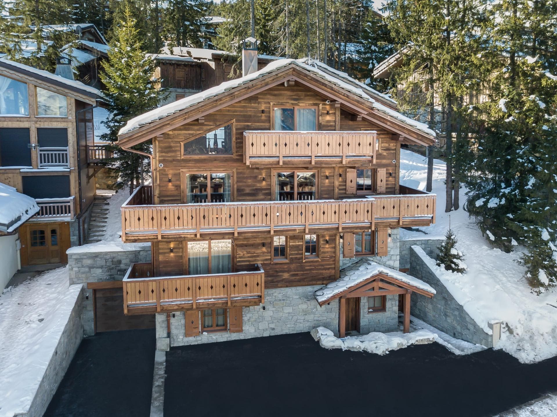 Ski-in chalet with heated driveway, private garage, and tiered balconies