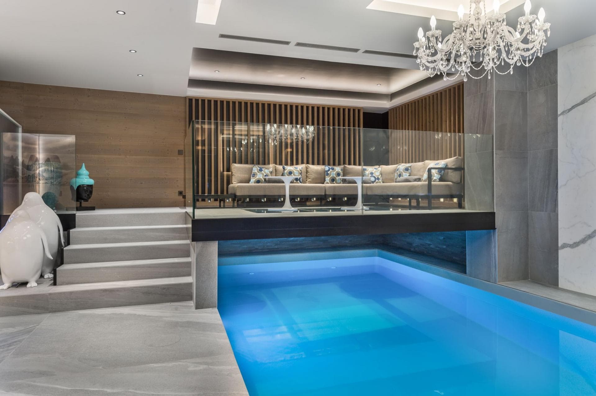 Indoor pool and mezzanine lounge with glass railing