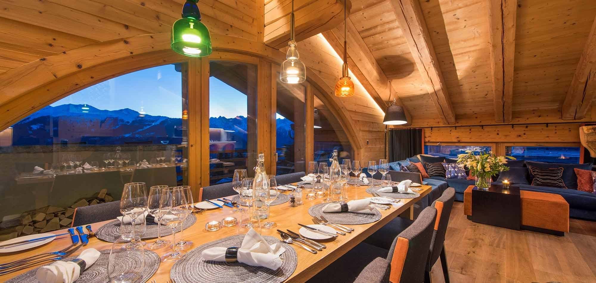 Dining room seats 8; floor-to-ceiling windows frame mountain and valley views