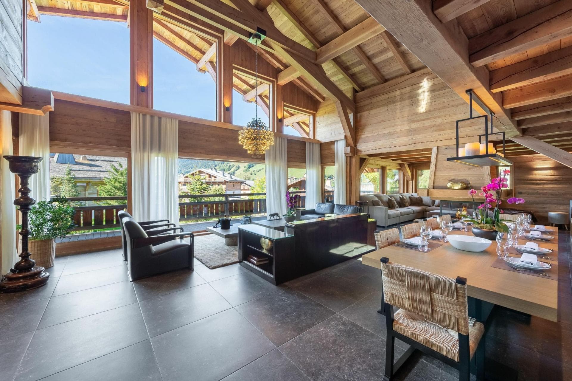 Open-plan living area with vaulted timber ceilings and dining seating for 10