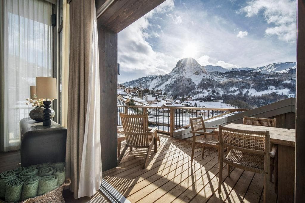 Balcony with dining table and mountain peak views