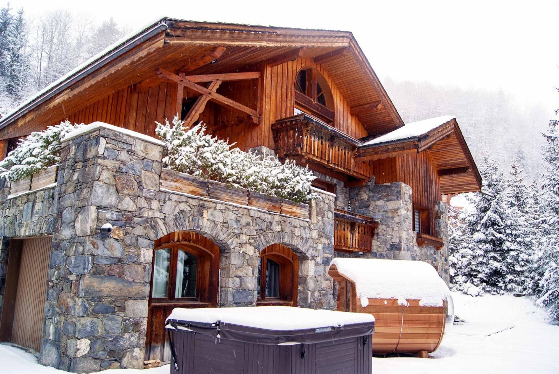 Chalet exterior with outdoor hot tub and barrel sauna