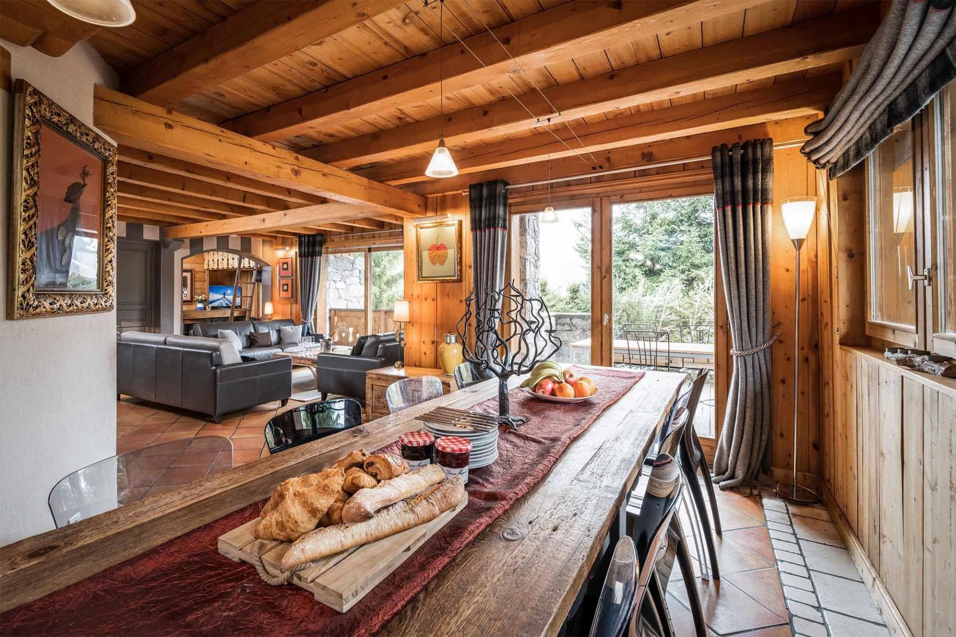 Open dining area with wood-beamed ceiling and terrace access