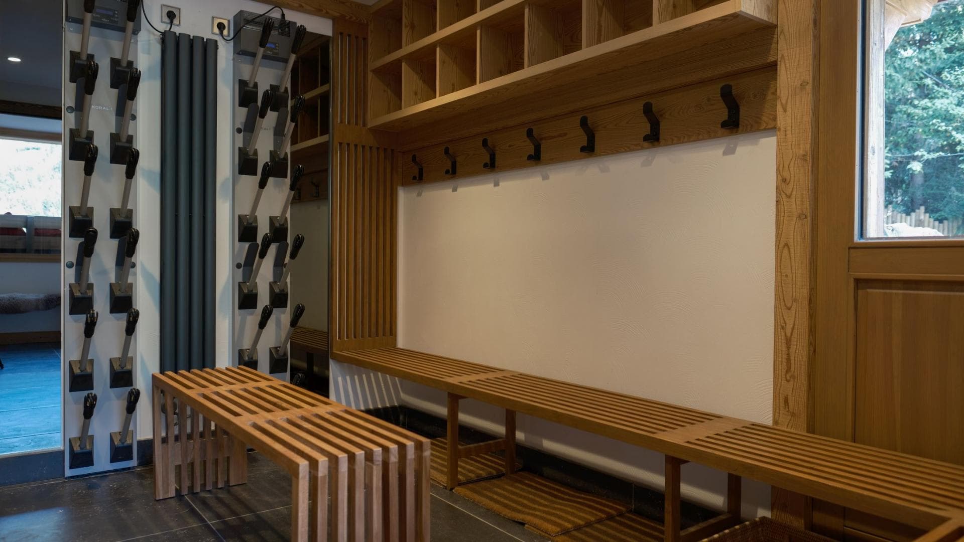 Ski boot room with heated dryers and bench seating