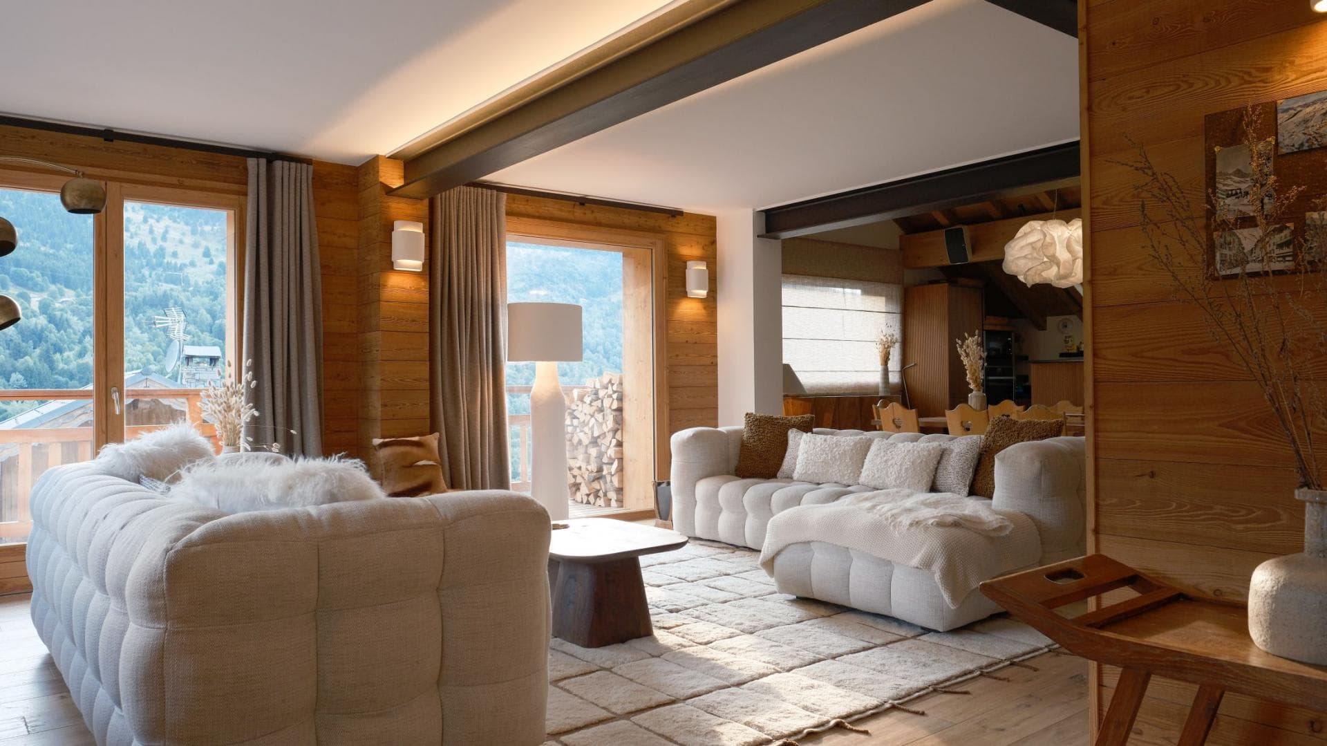 Living area with plush sectional seating and floor-to-ceiling mountain views