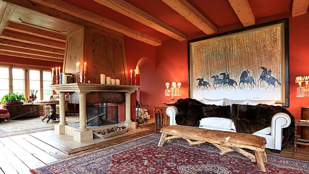 Living area with wood-burning fireplace and exposed timber ceilings