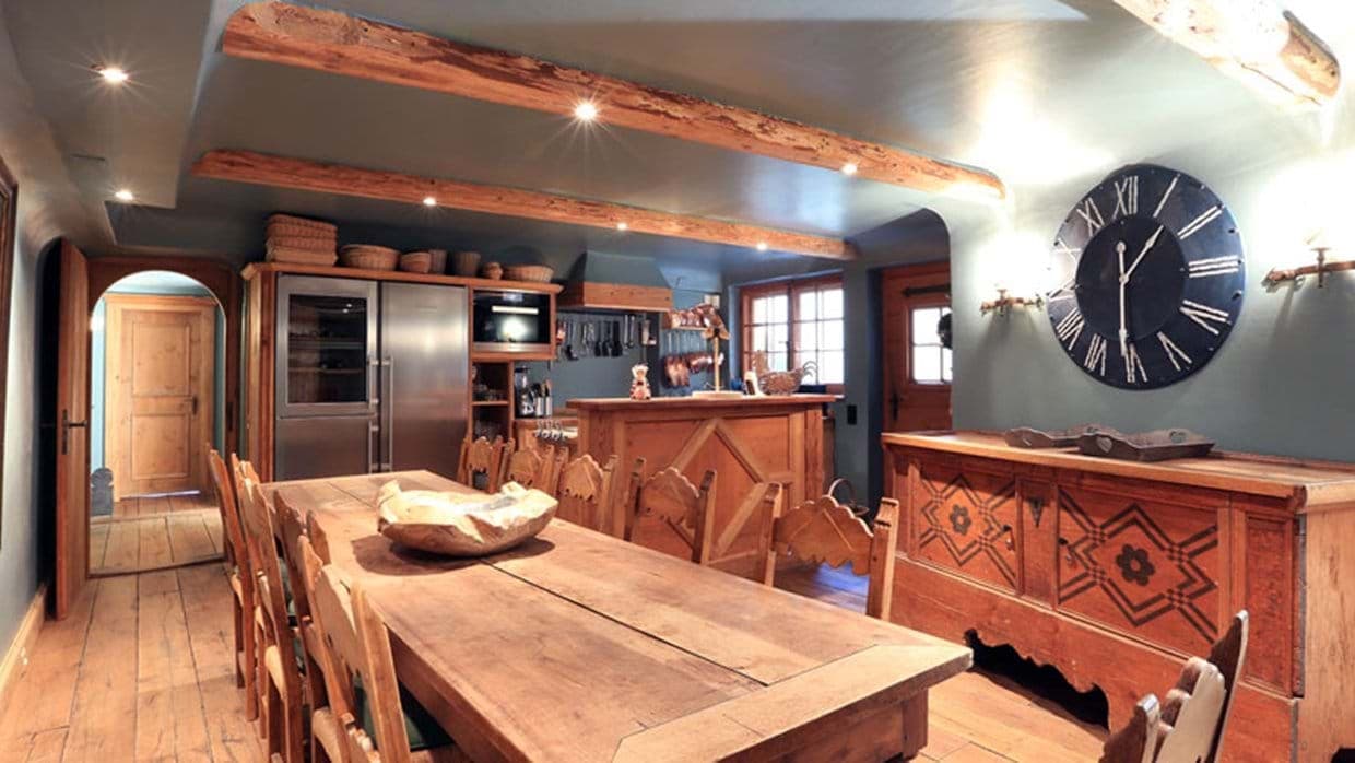 Dining area and kitchen with exposed beams and seating for 10