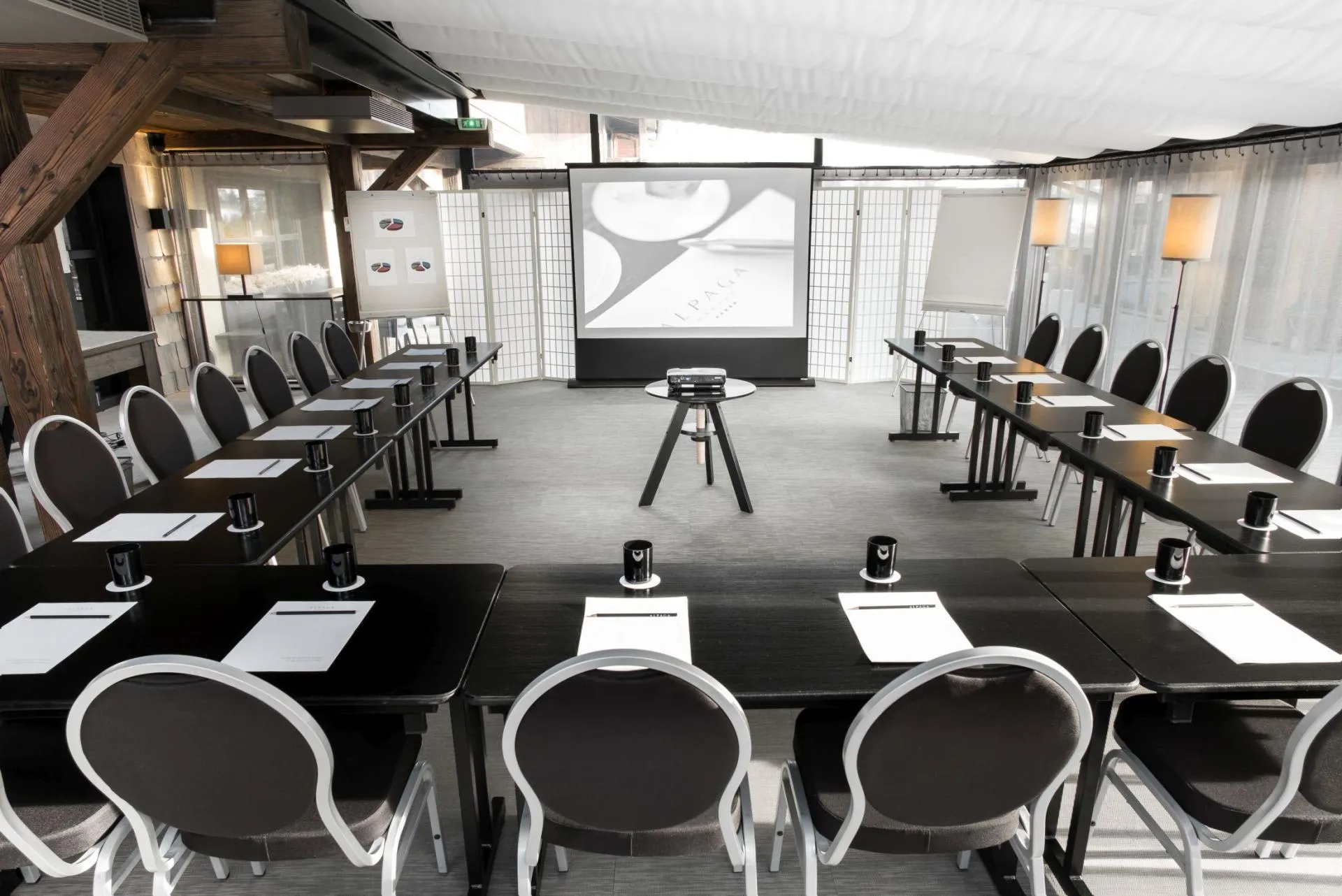 Meeting room with U-shaped seating for 20 and projection equipment