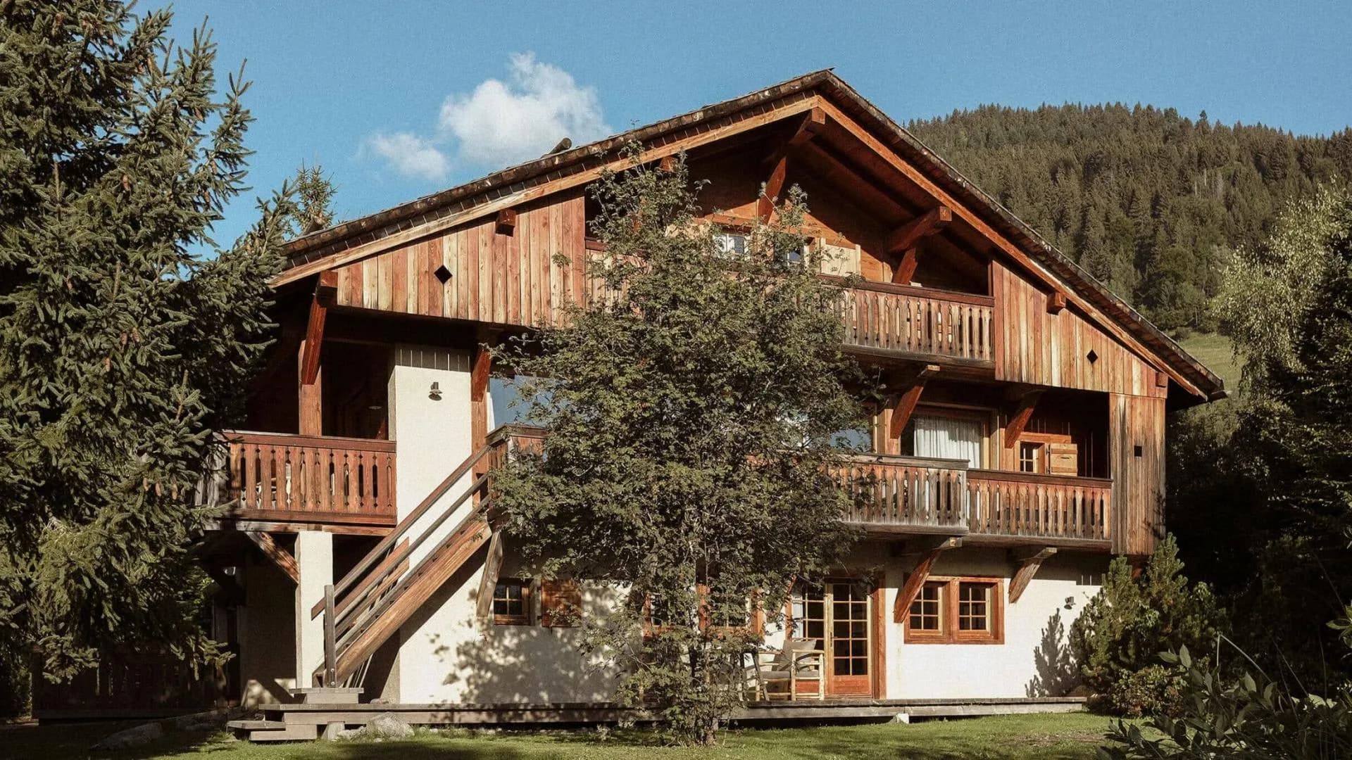 Timber chalet with three levels of wraparound balconies and mountain views
