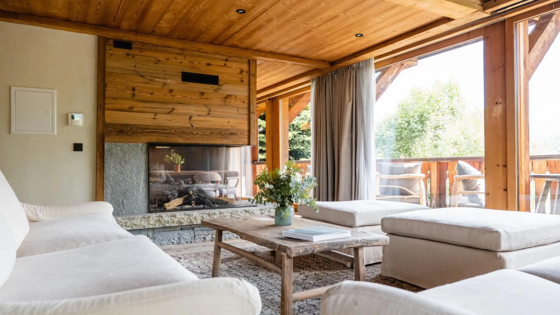 Living area with see-through fireplace and access to balcony seating