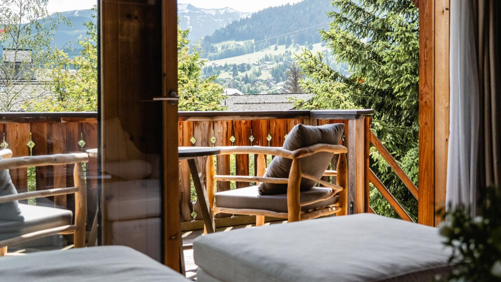 Private balcony with mountain views and wood-frame lounge seating