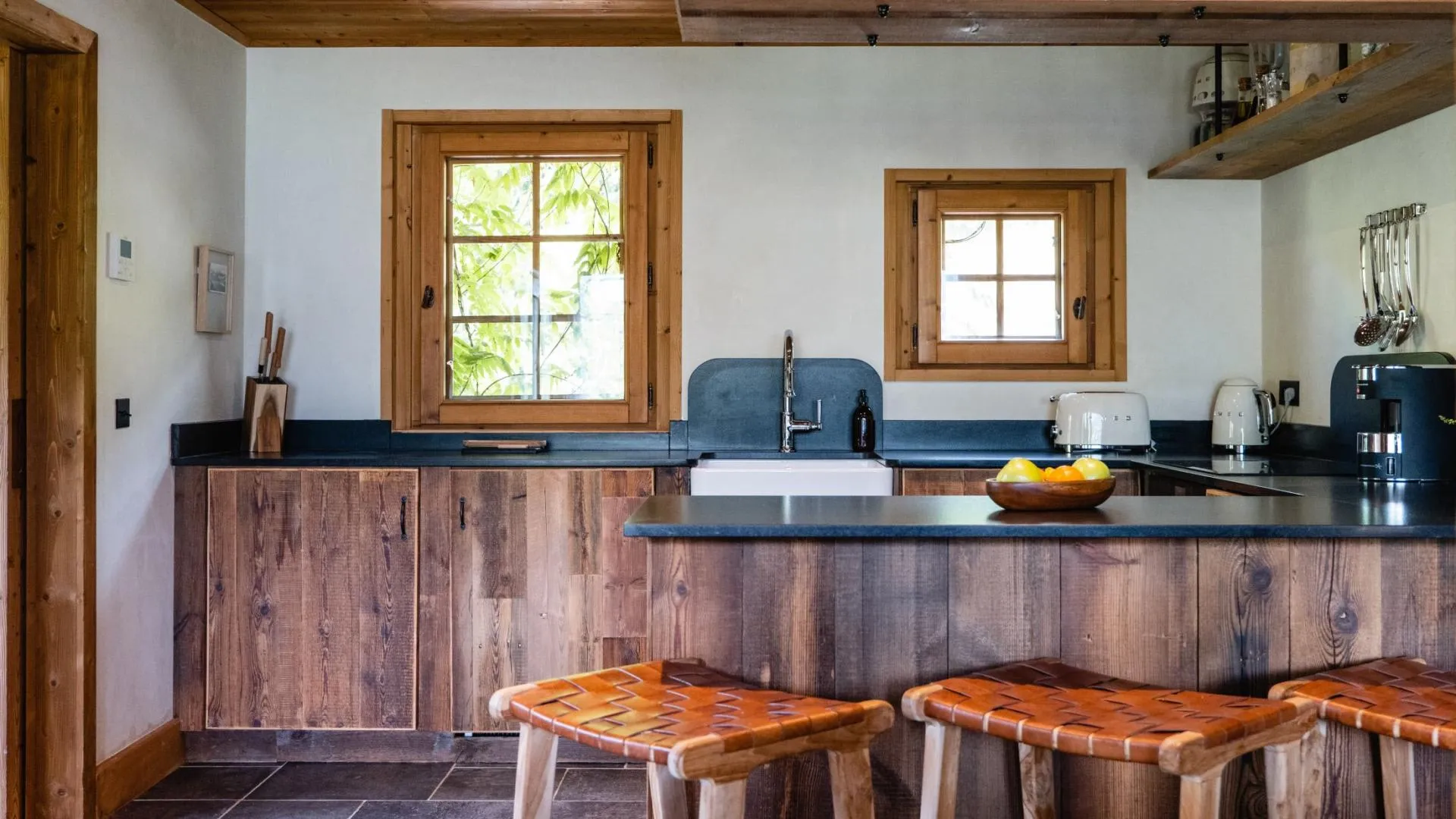 Kitchen with farmhouse sink and breakfast bar seating for 3