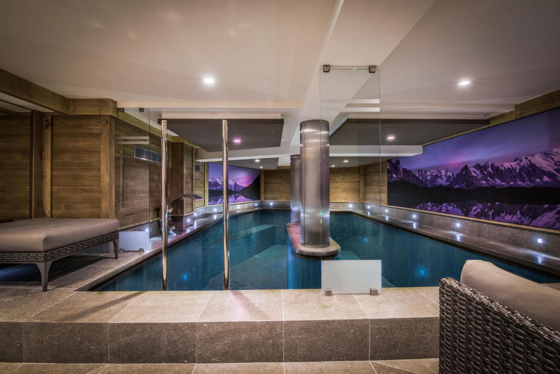 Indoor pool with swan neck massage jet and lounge seating