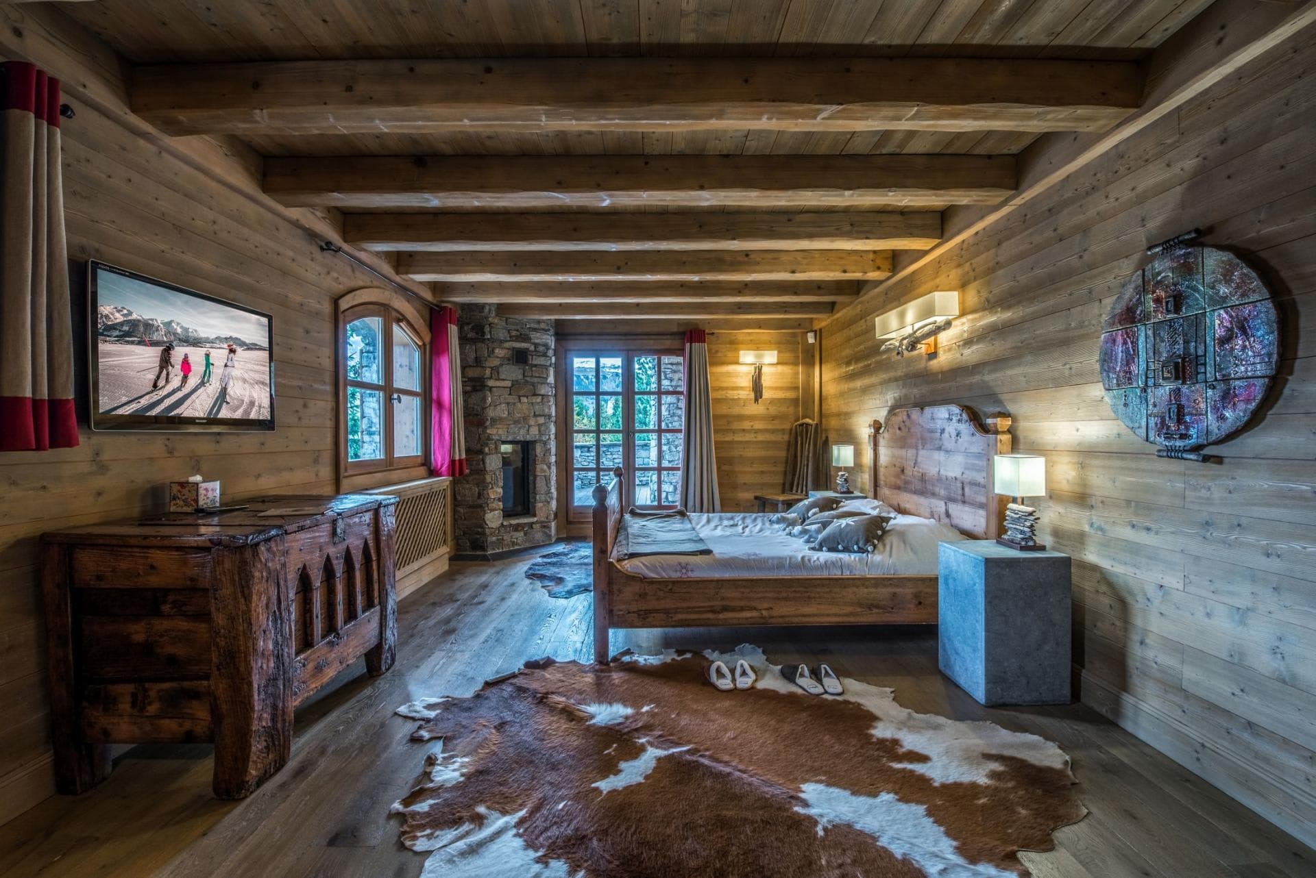 Primary bedroom with stone fireplace and terrace access