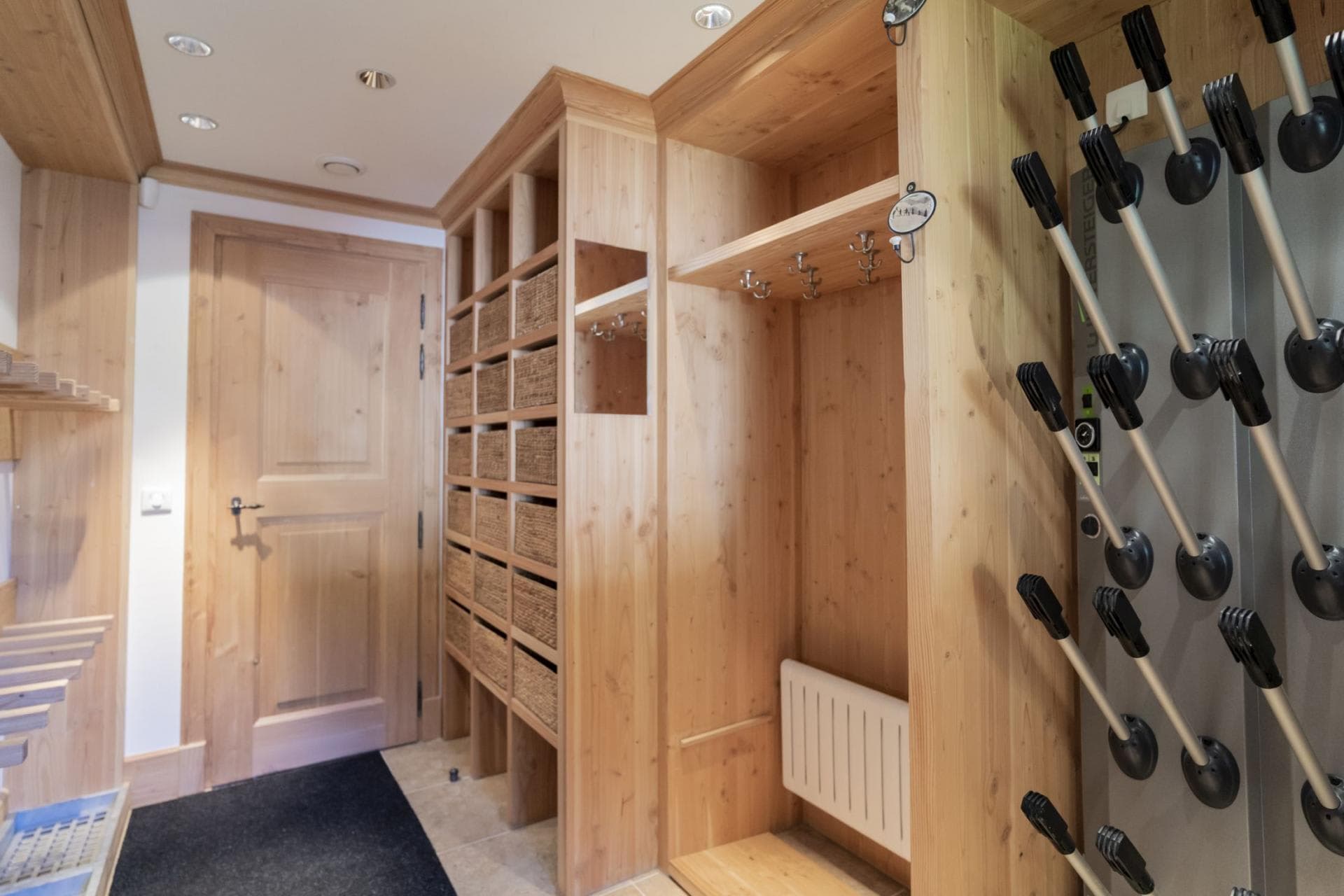 Ski room with heated boot rack and individual storage cubbies
