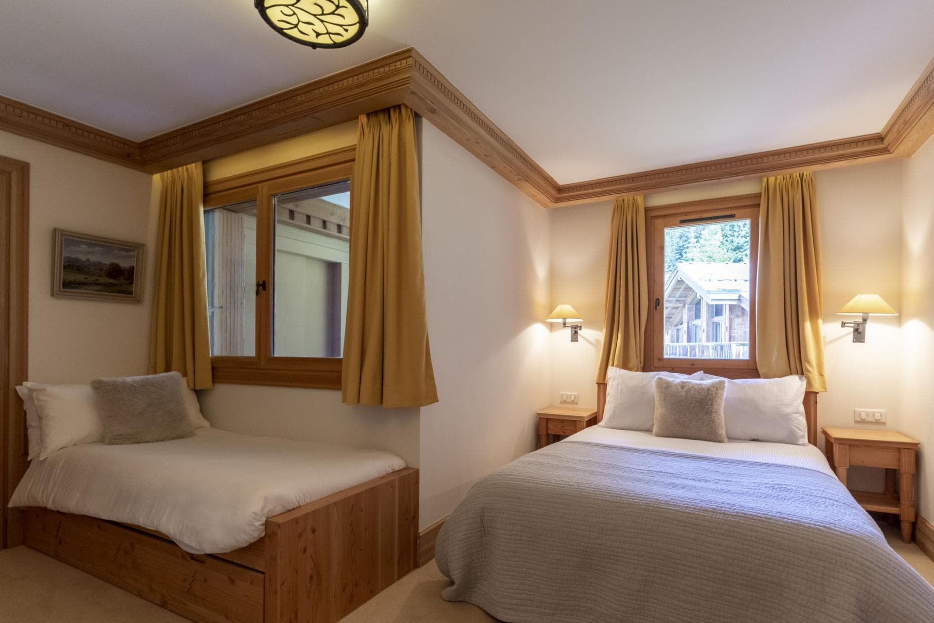 Bedroom with queen bed and built-in single bed; timber trim