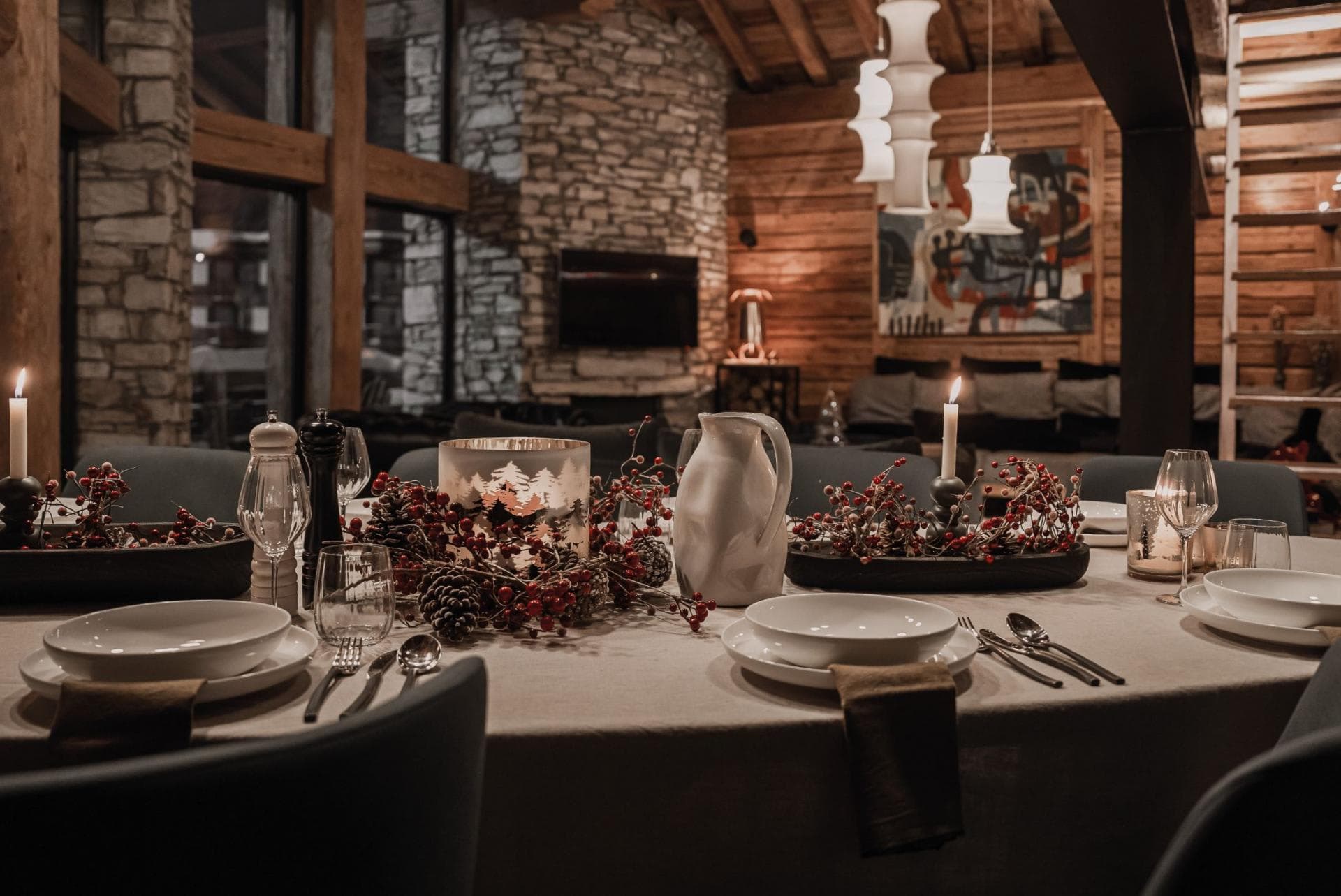 Dining area adjacent to living room fireplace and stone accent wall