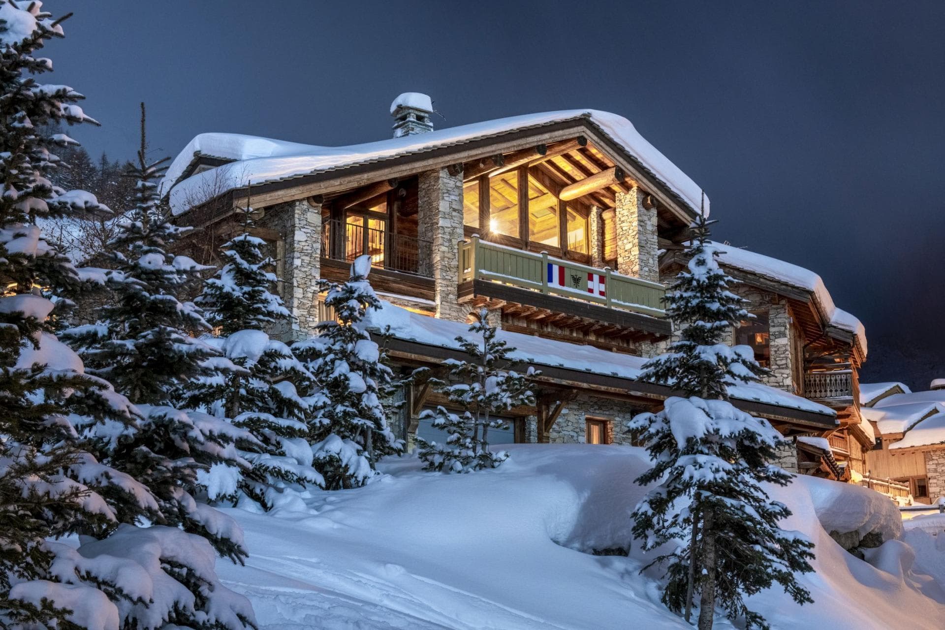 Ski-in, ski-out chalet exterior with stone facade and private balconies