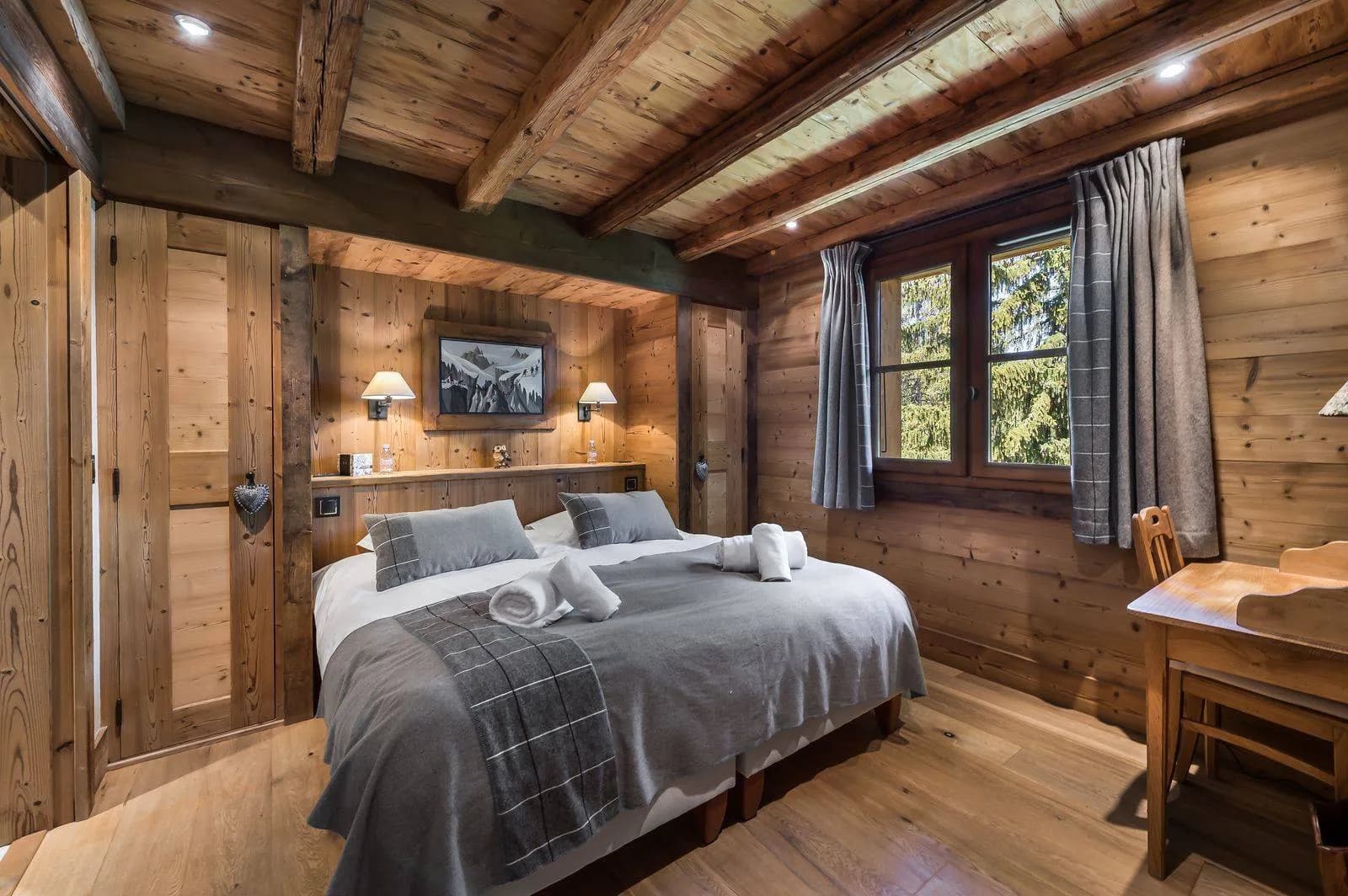 Wood-panelled double bedroom with timber beams
