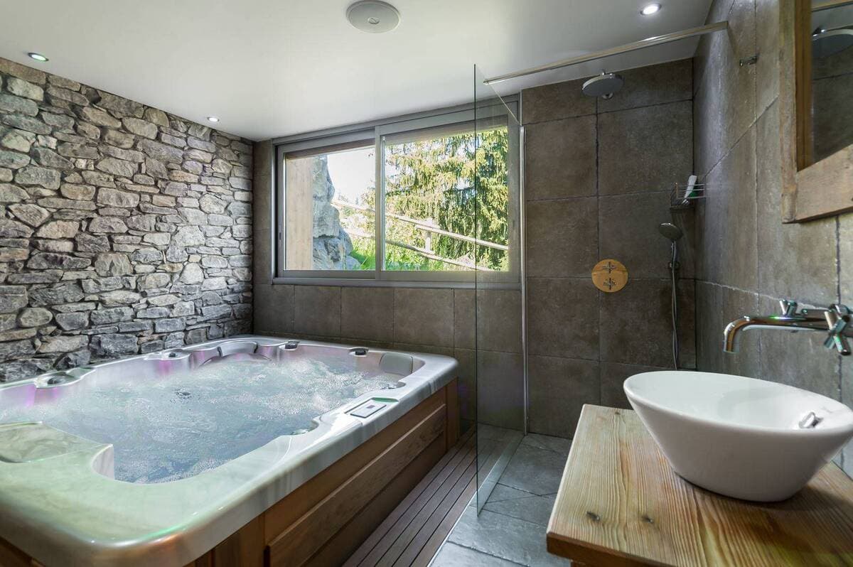 Spa room with jetted hot tub and walk-in rain shower