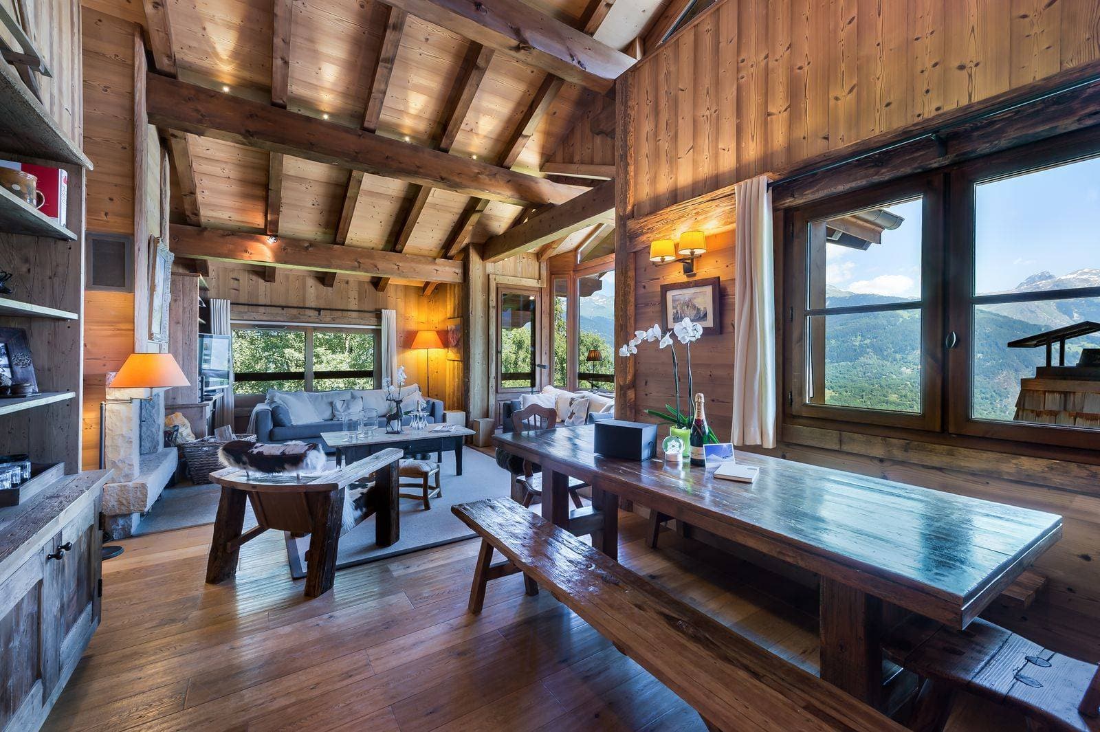 Open-plan living room with a timber ceiling and mountain views