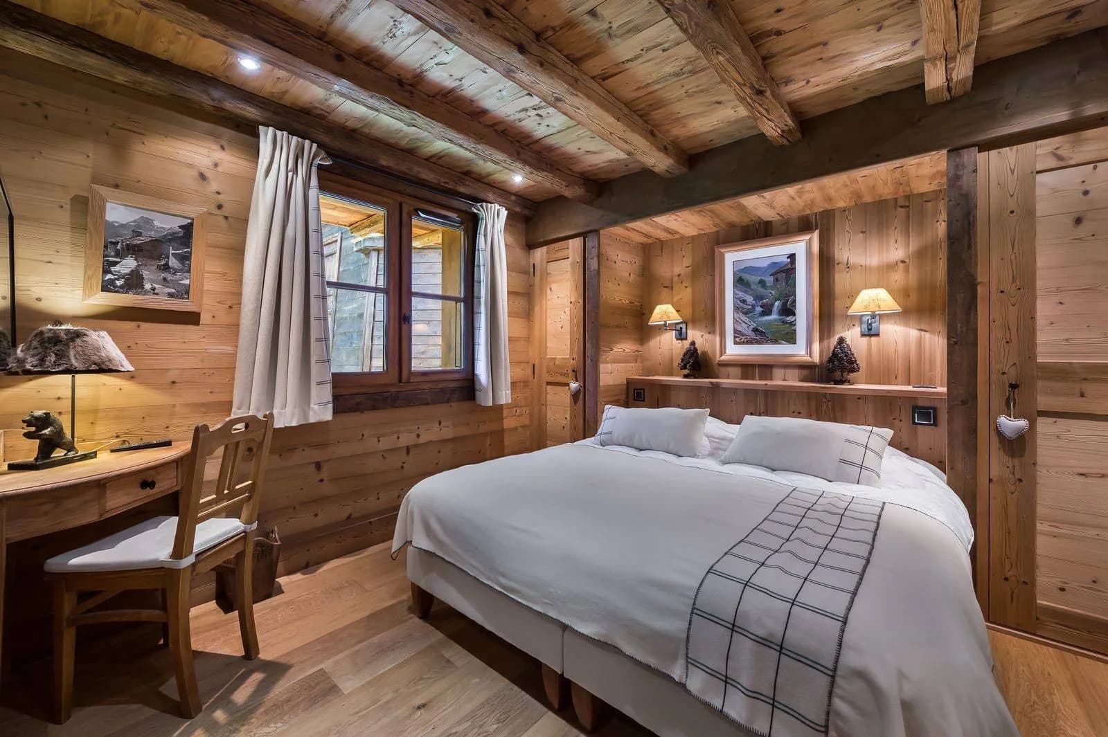 Wood-panelled double bedroom with television and seating