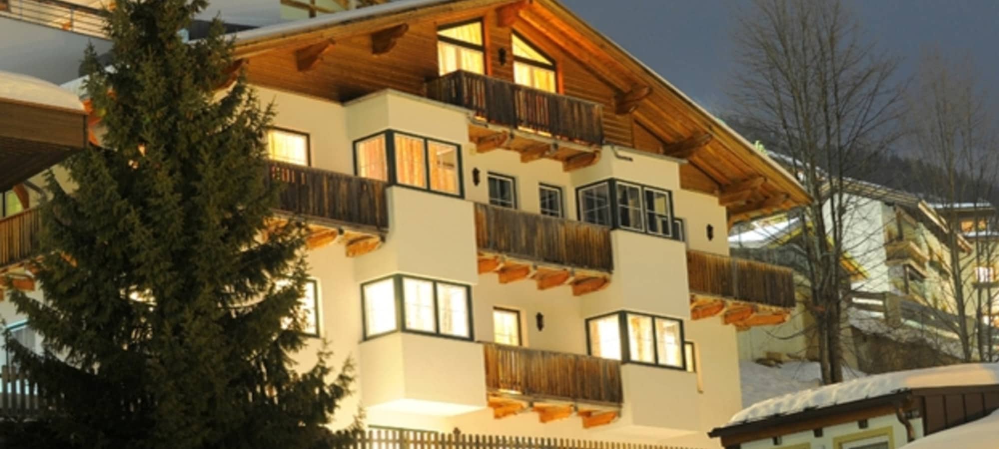 Chalet exterior with multiple private balconies and wood-beam architecture