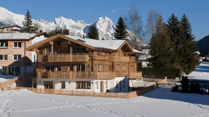 Timber chalet with wrap-around balconies and alpine mountain views