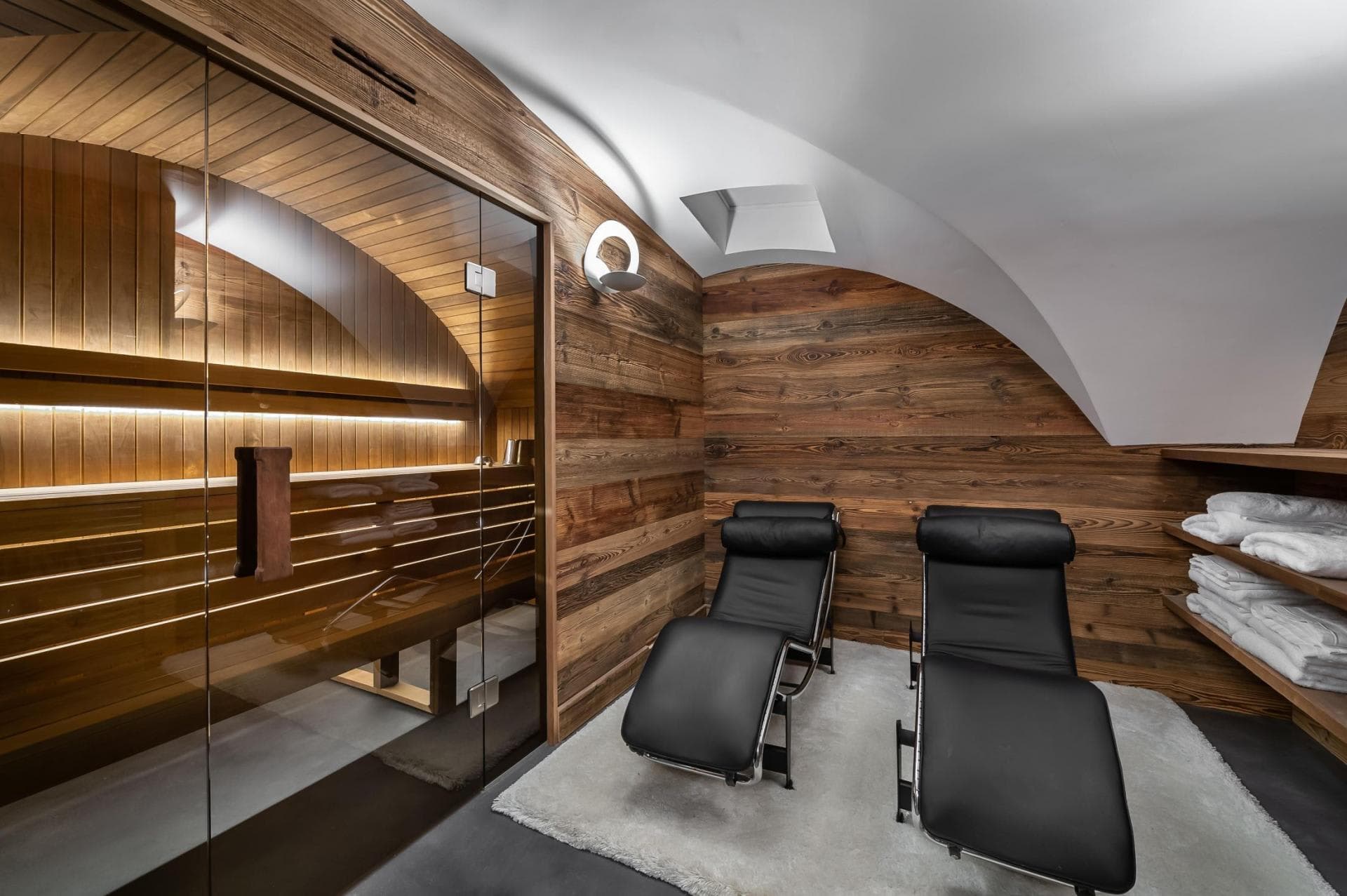 Private sauna and relaxation room with leather loungers and fresh towels