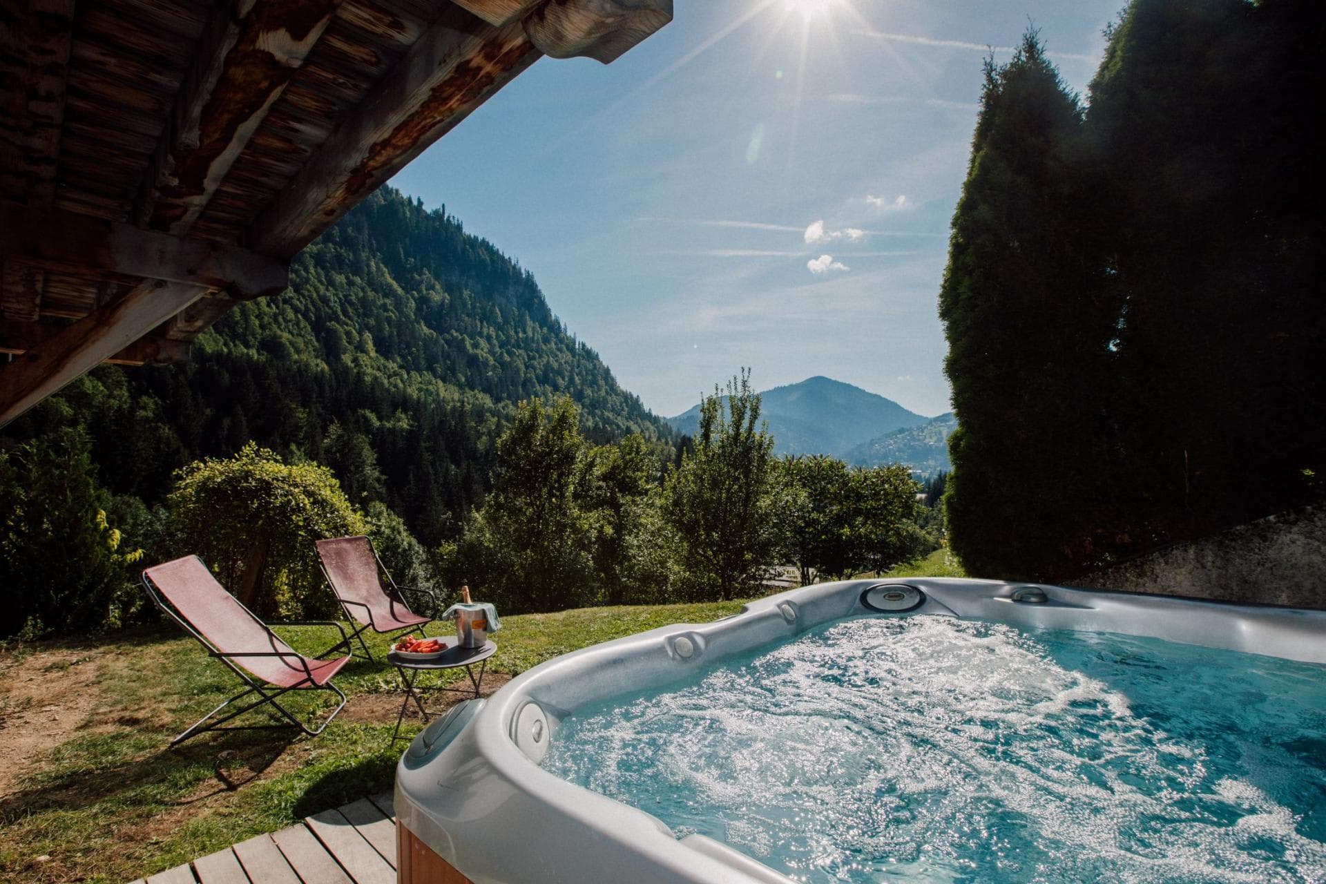 Outdoor hot tub and lounge seating with panoramic mountain views