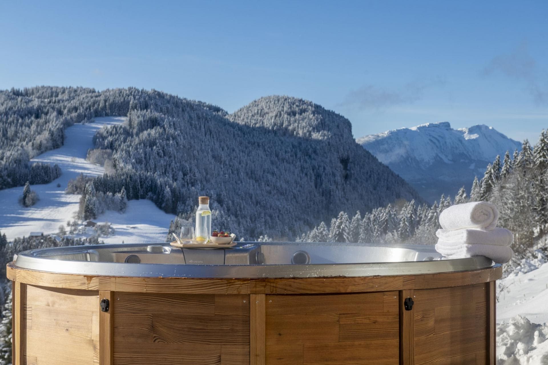 Outdoor cedar hot tub with views of nearby ski runs