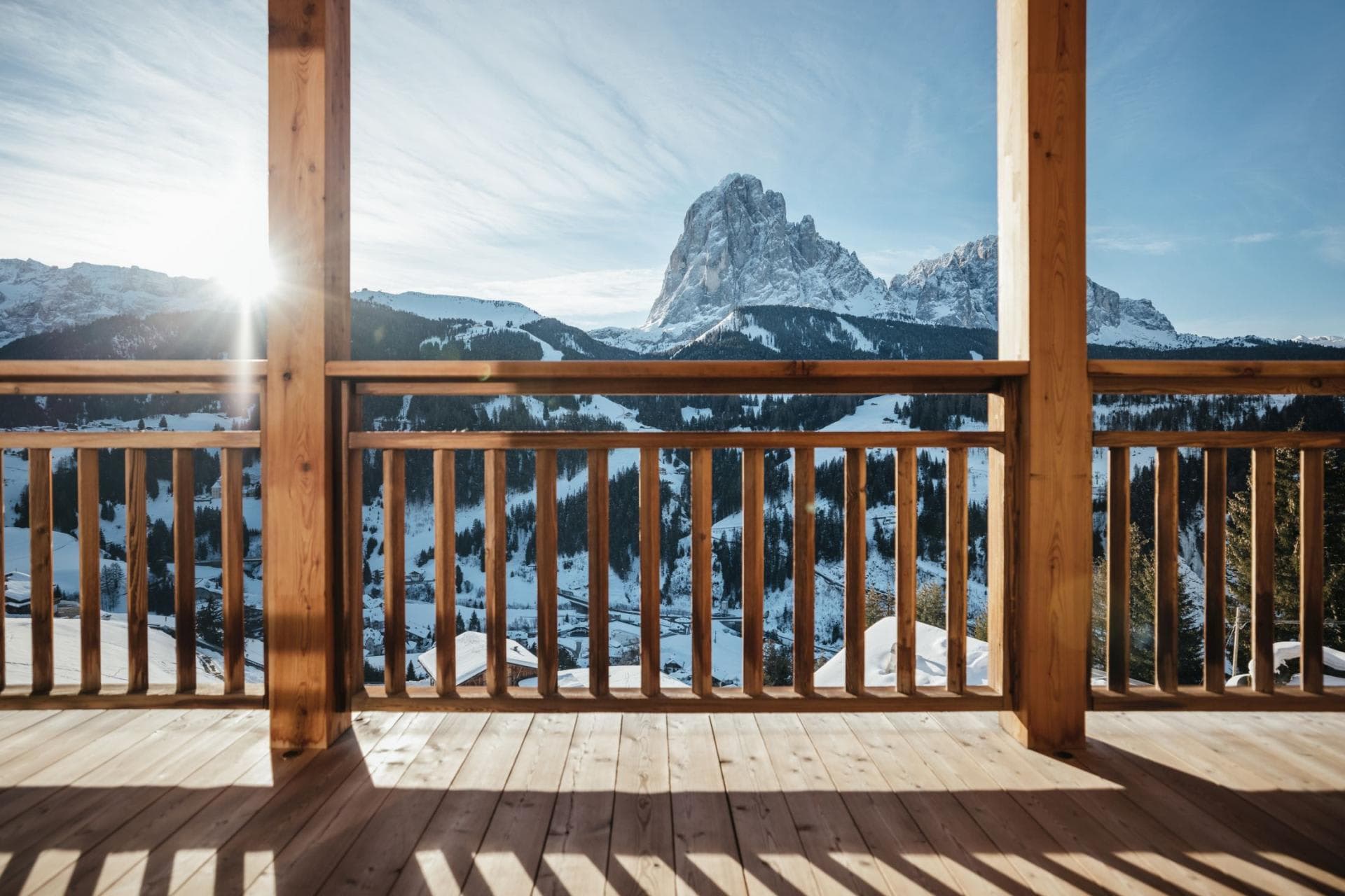 Covered timber balcony with panoramic Dolomite mountain and valley views