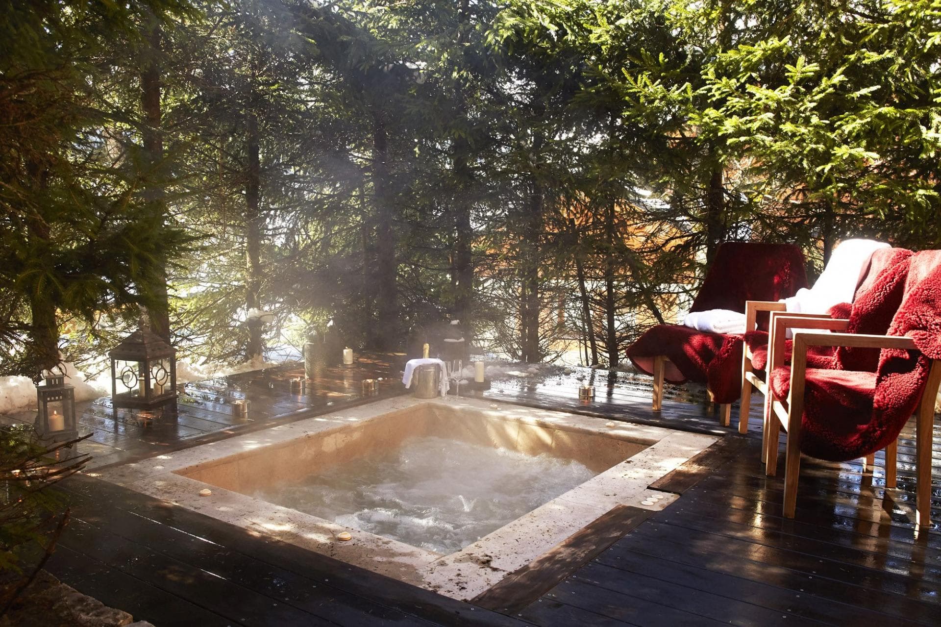 Sunken outdoor hot tub on timber deck with forest privacy