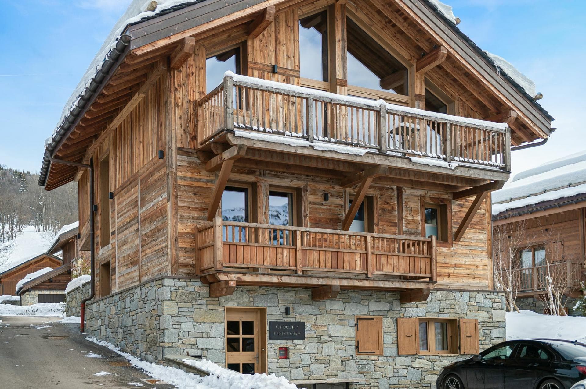 Ski-in chalet with timber facade and private balconies on multiple levels